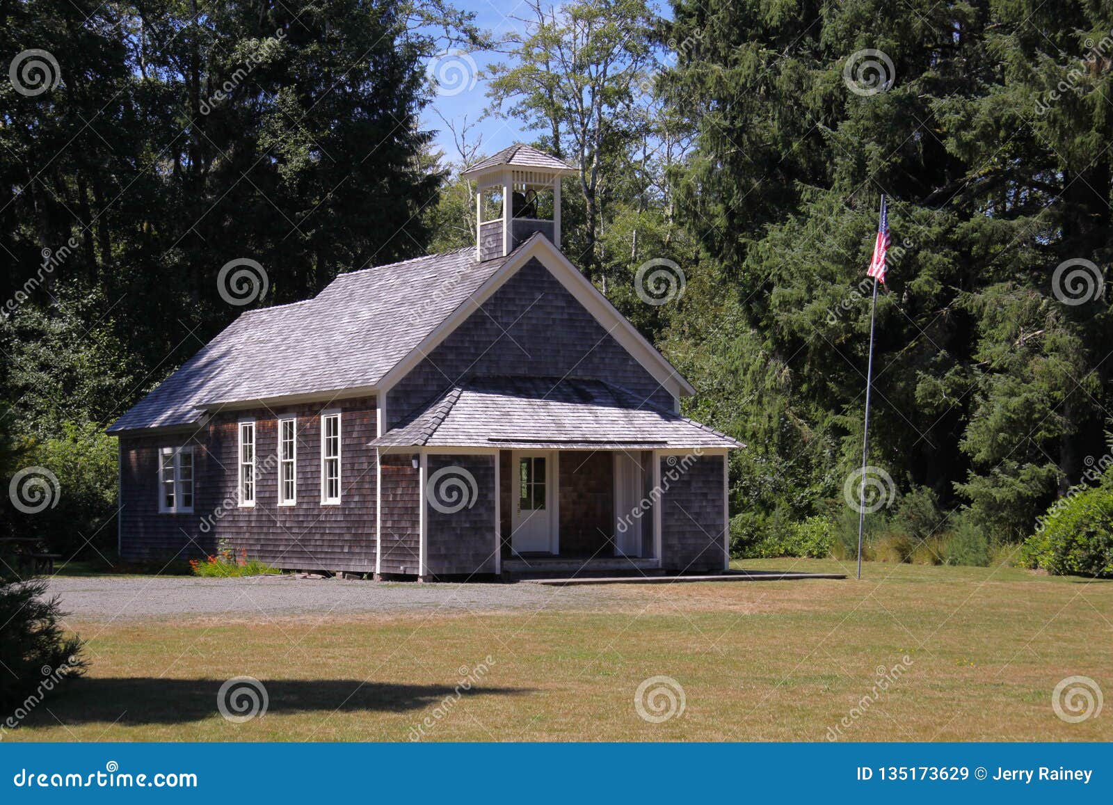 old schoolhouse with flagpole