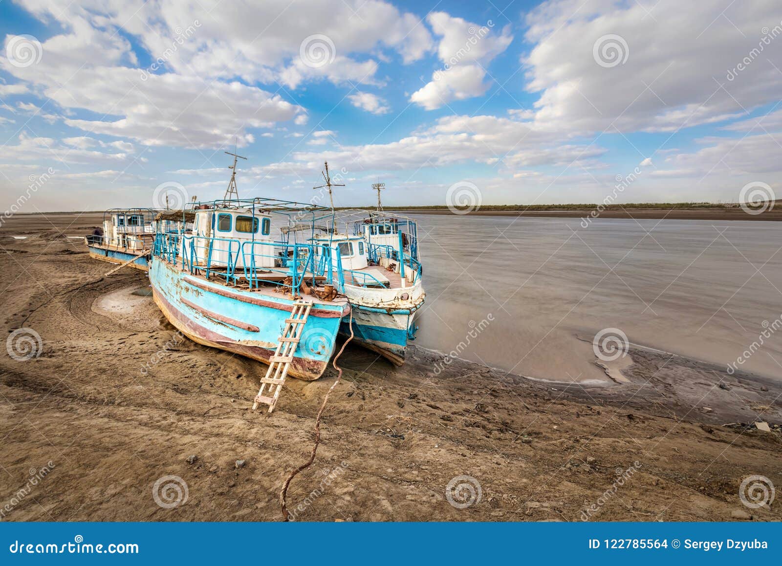 old ships on the shore of a drying amu darya river, uzbekistan