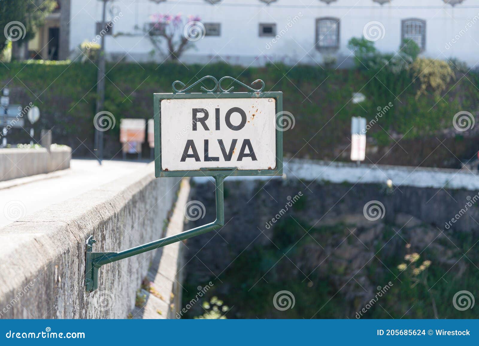 old sign \'\'rio alva\'\' on a stone bridge in the historic town of portugal called coja