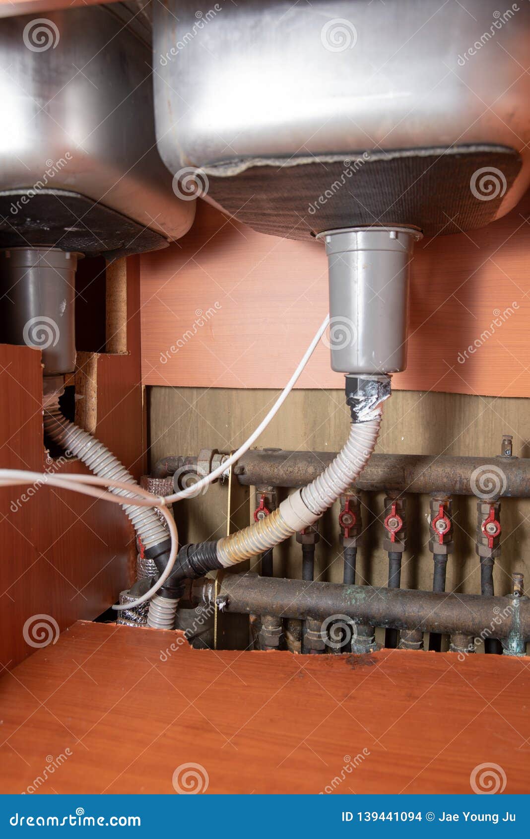 Old Sinks and Boiler Piping that Need Repair. Stock Photo Image of