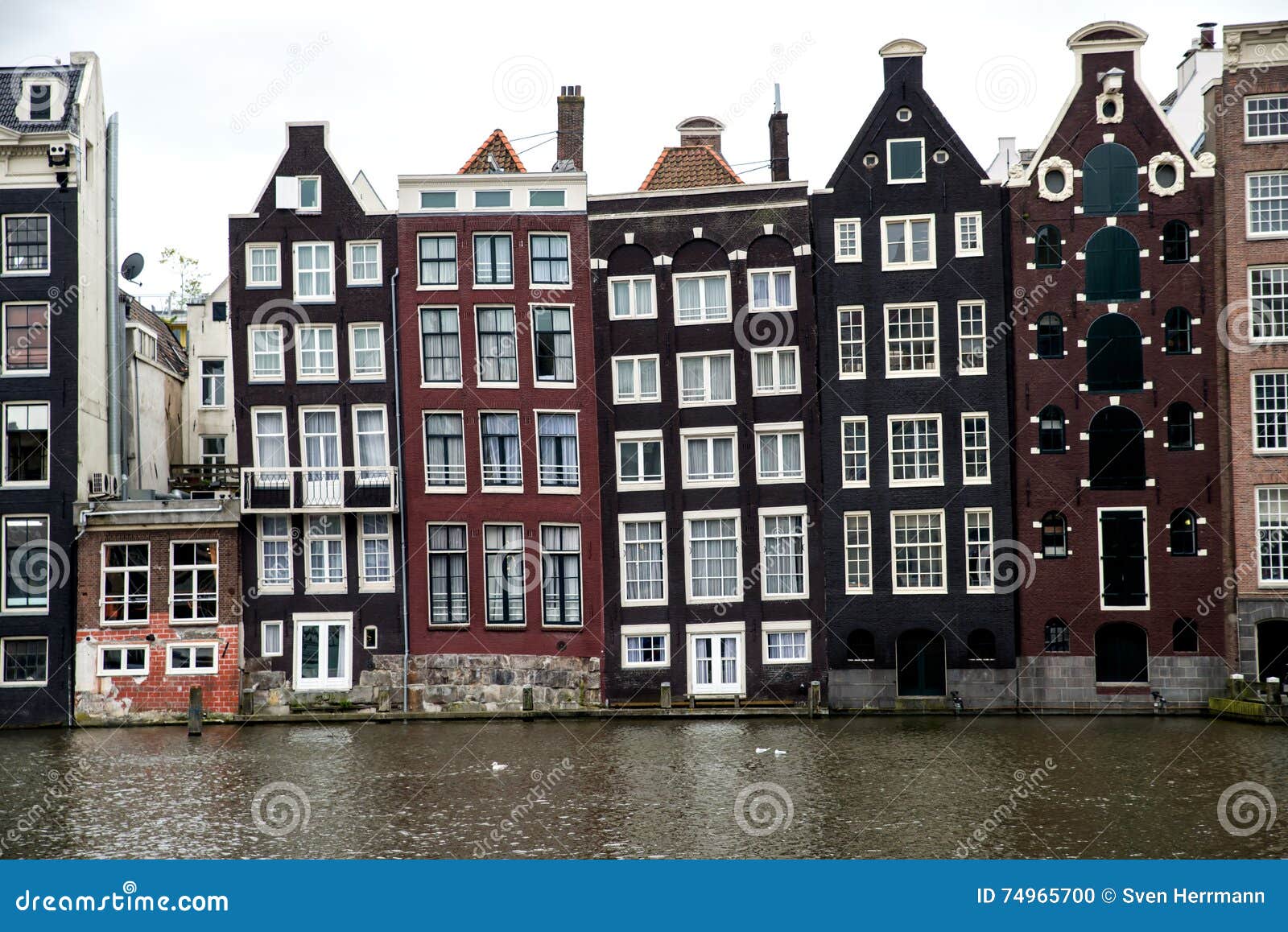 old slanting canal buildings in amsterdam