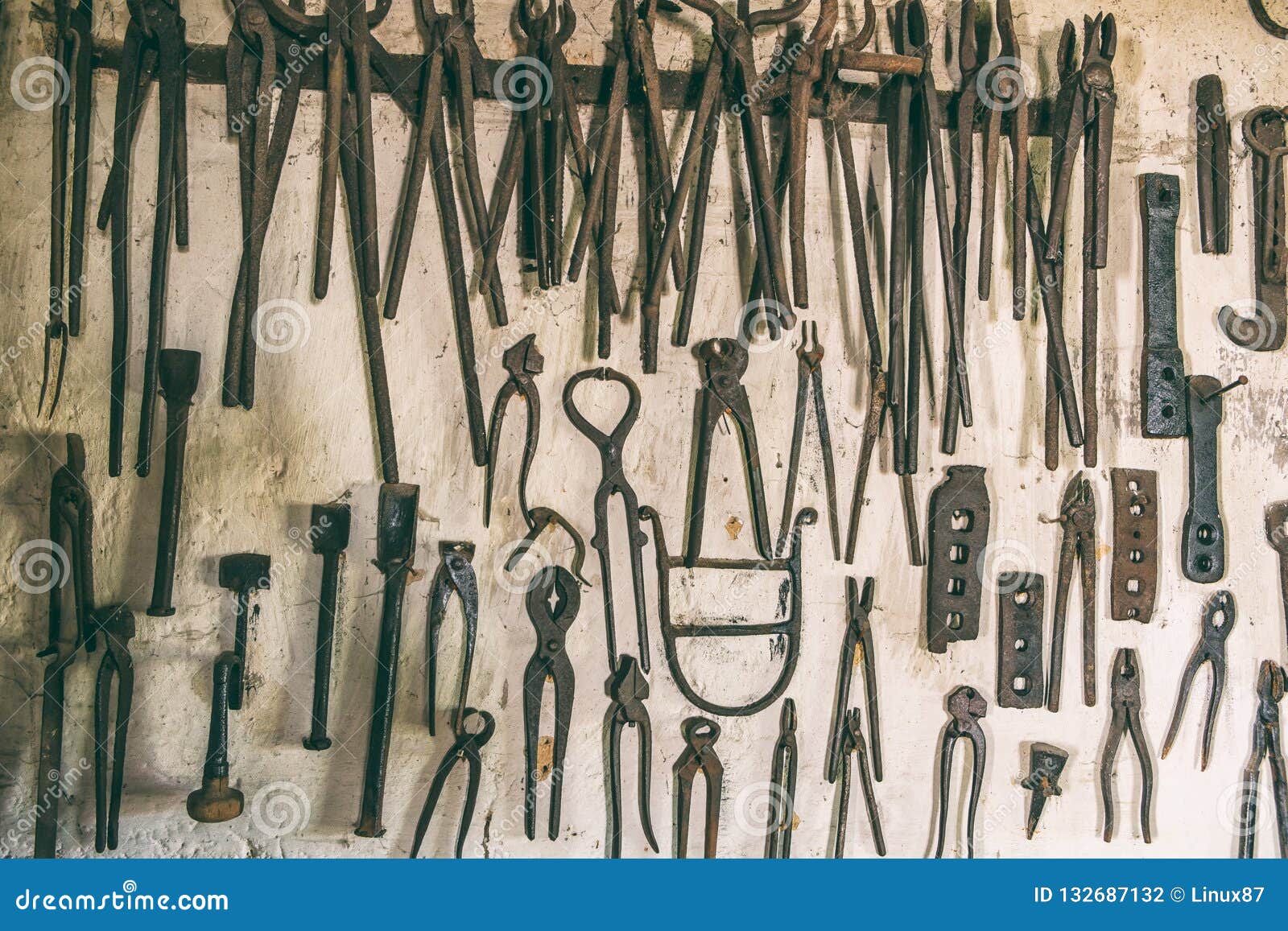 Smithy tools on the wall stock photo. Image of horseshoe 132687132