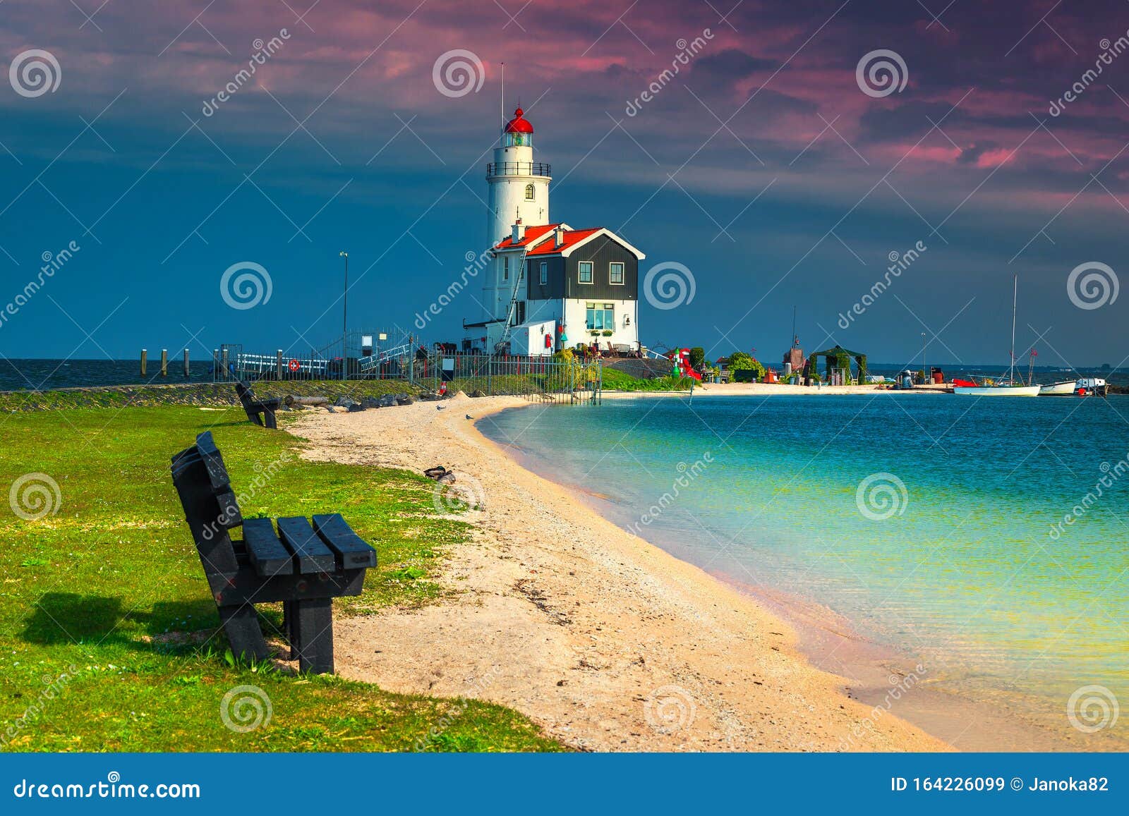 old spectacular lighthouse on the seashore, marken, netherlands, europe