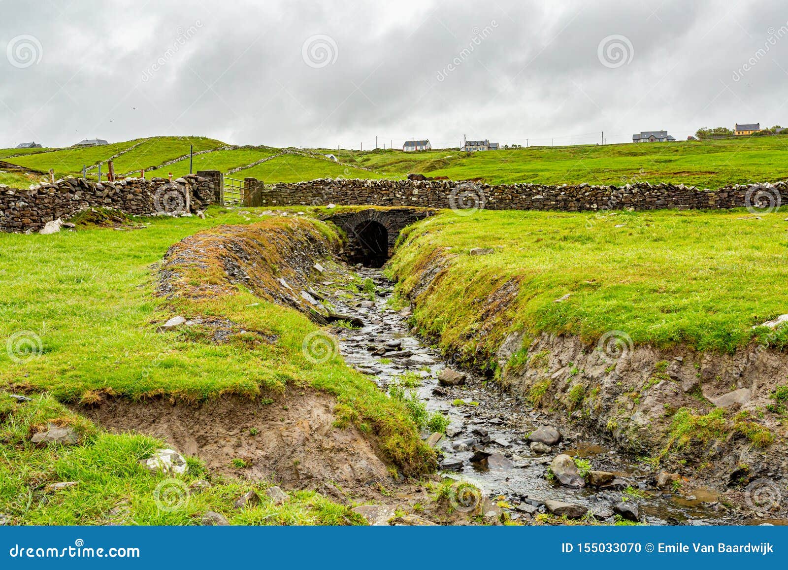 old stone bridge over a stream on the coastal walk route from doolin to the cliffs of moher