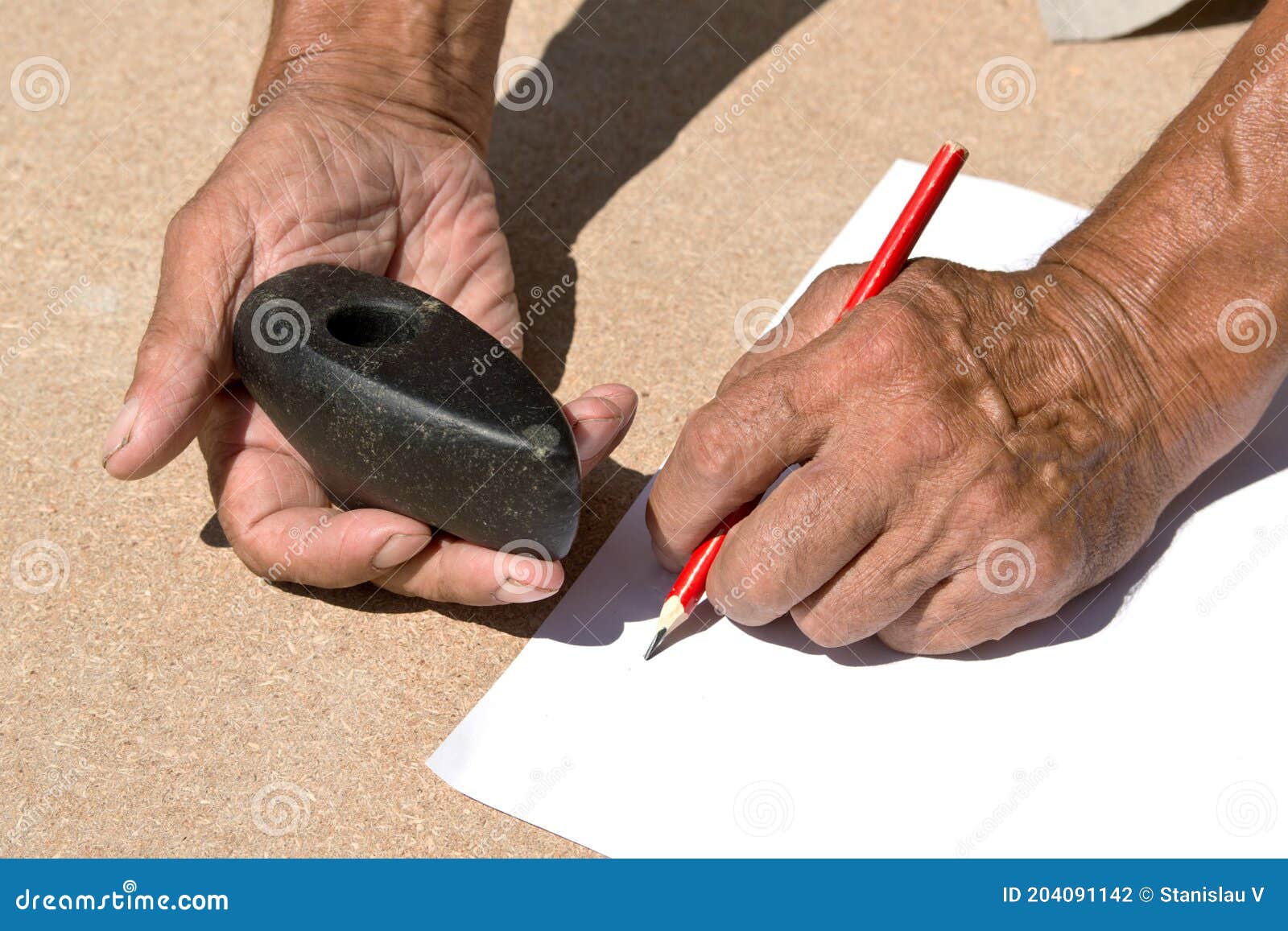 An Old Stone Hammer an Elder Man Holds in His Hands. Archaeology Stock