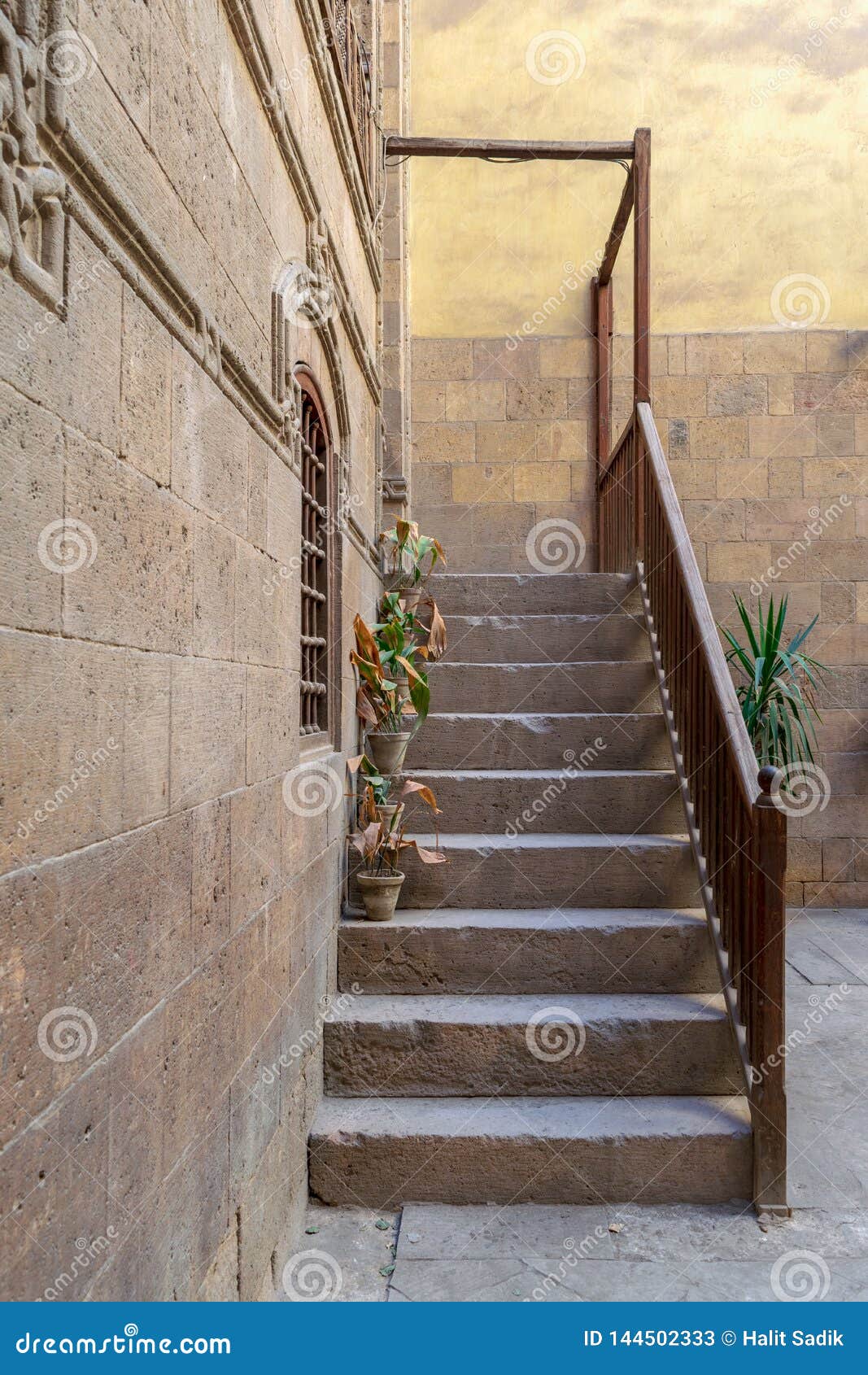 old stone stair case with wooden balustrade, old cairo, egypt