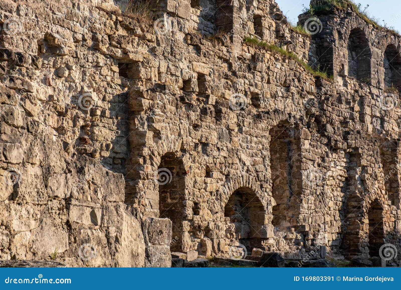 old stone wall with windows, ruins of an ancient castle