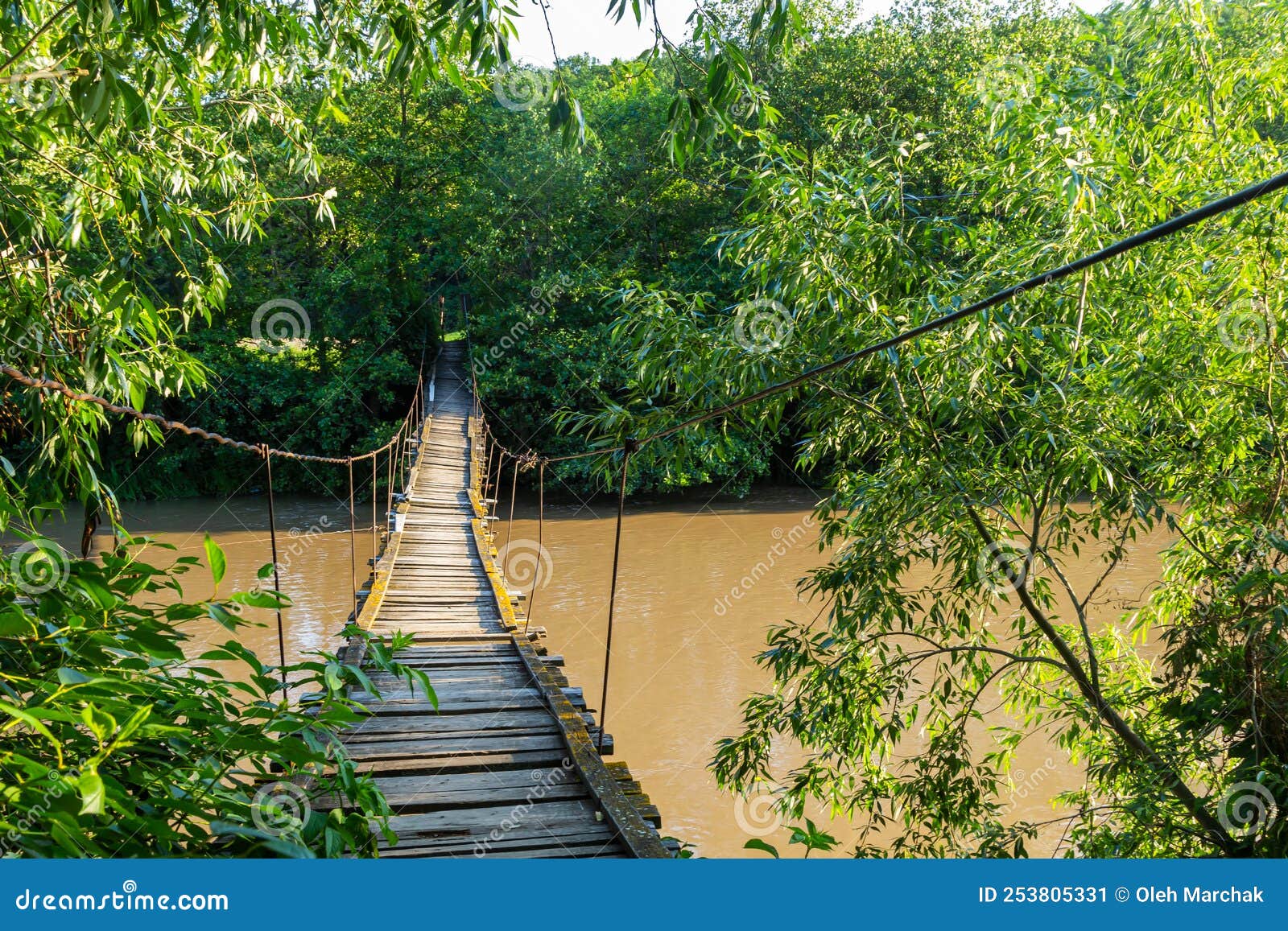 Old Suspension Bridge Over the River in the Countryside Going into