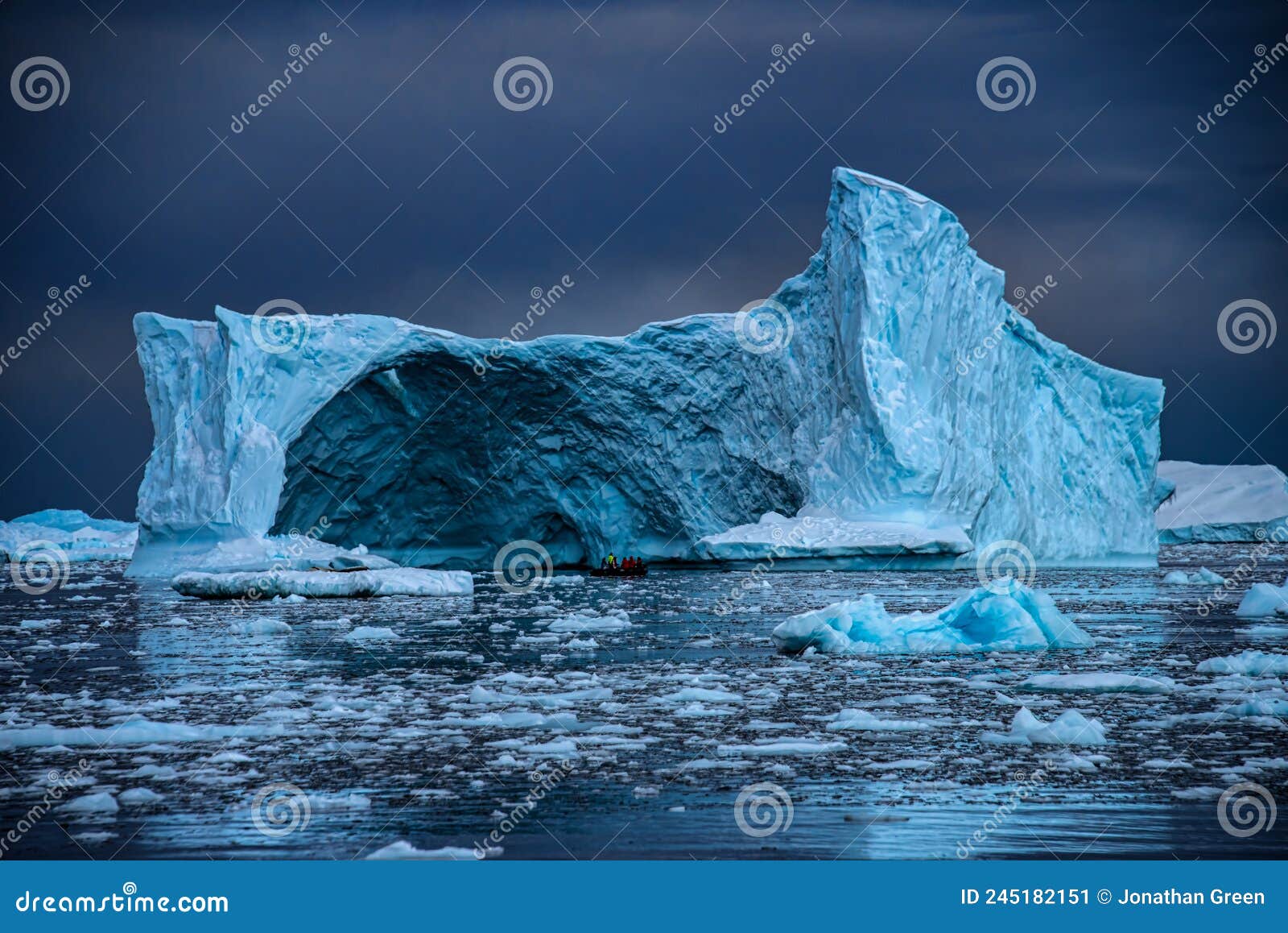 old tabular iceberg with zodiac and expedition group, antarctica