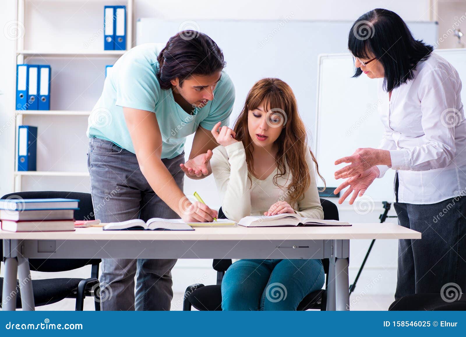 Old Teacher and Students in the Classroom Stock Image - Image of
