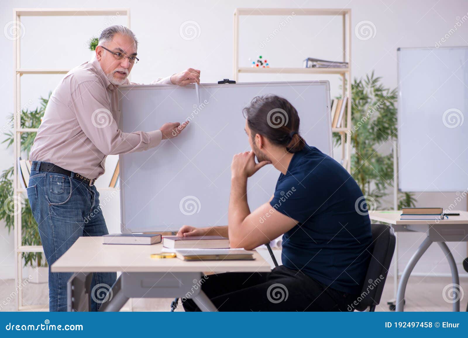 Old Teacher And Young Male Student In The Classroom Stock Photo Image