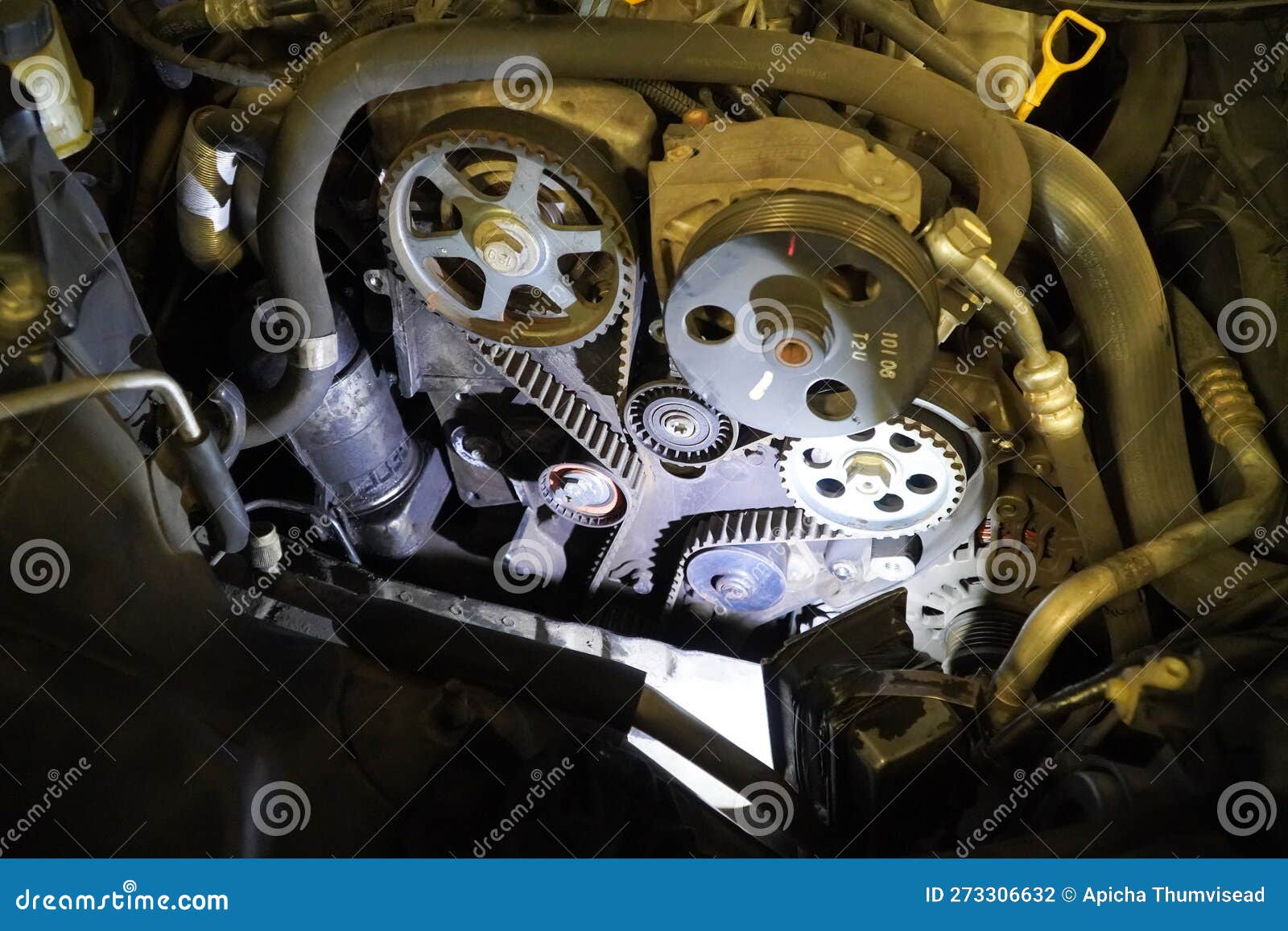 Old Timing Belt with Rollers Mounted on an Old Engine in the Garage