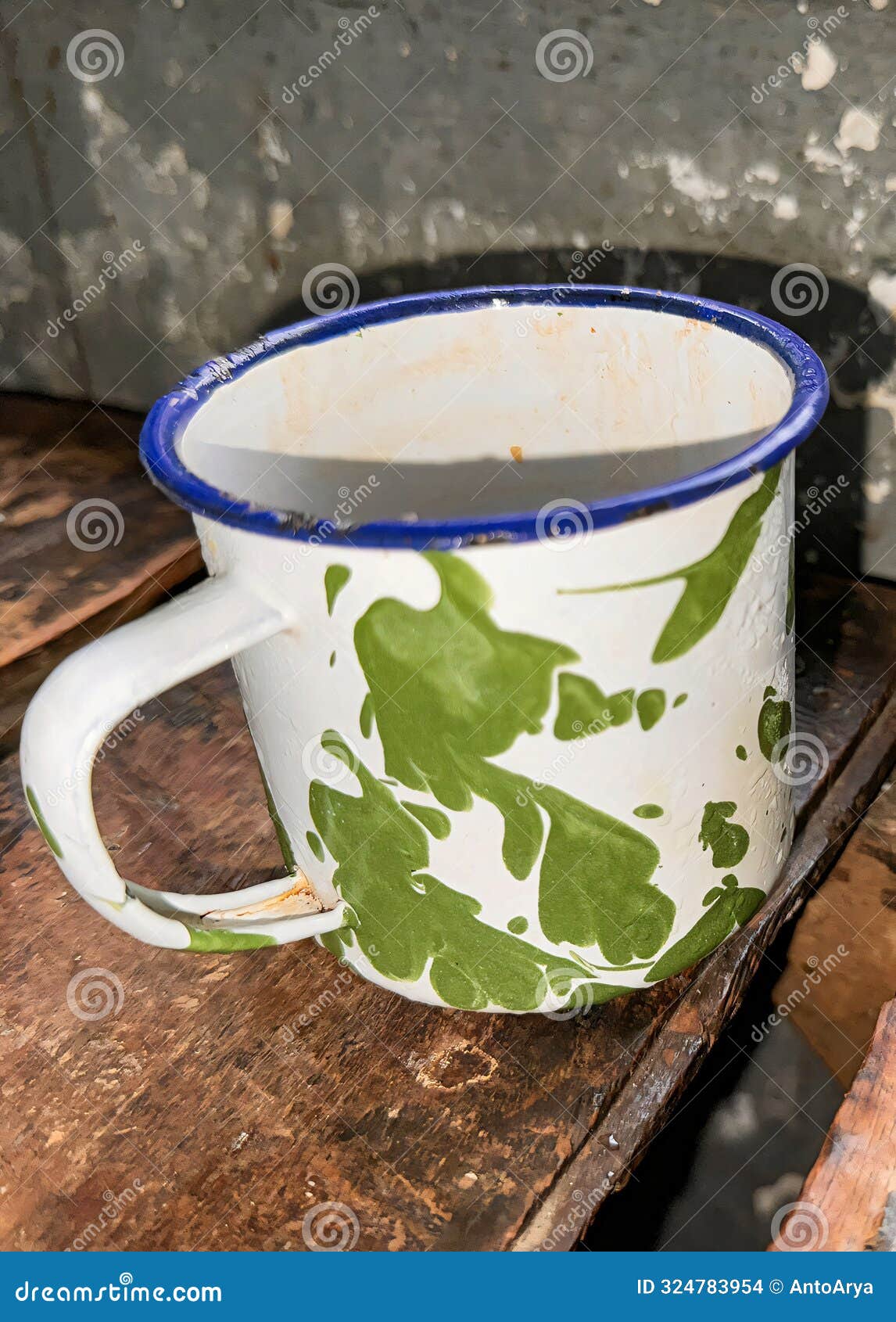the old tin cup utensils on the table in the asian prison ward, local called as cangkir blirik, drinking tin cup used in asian