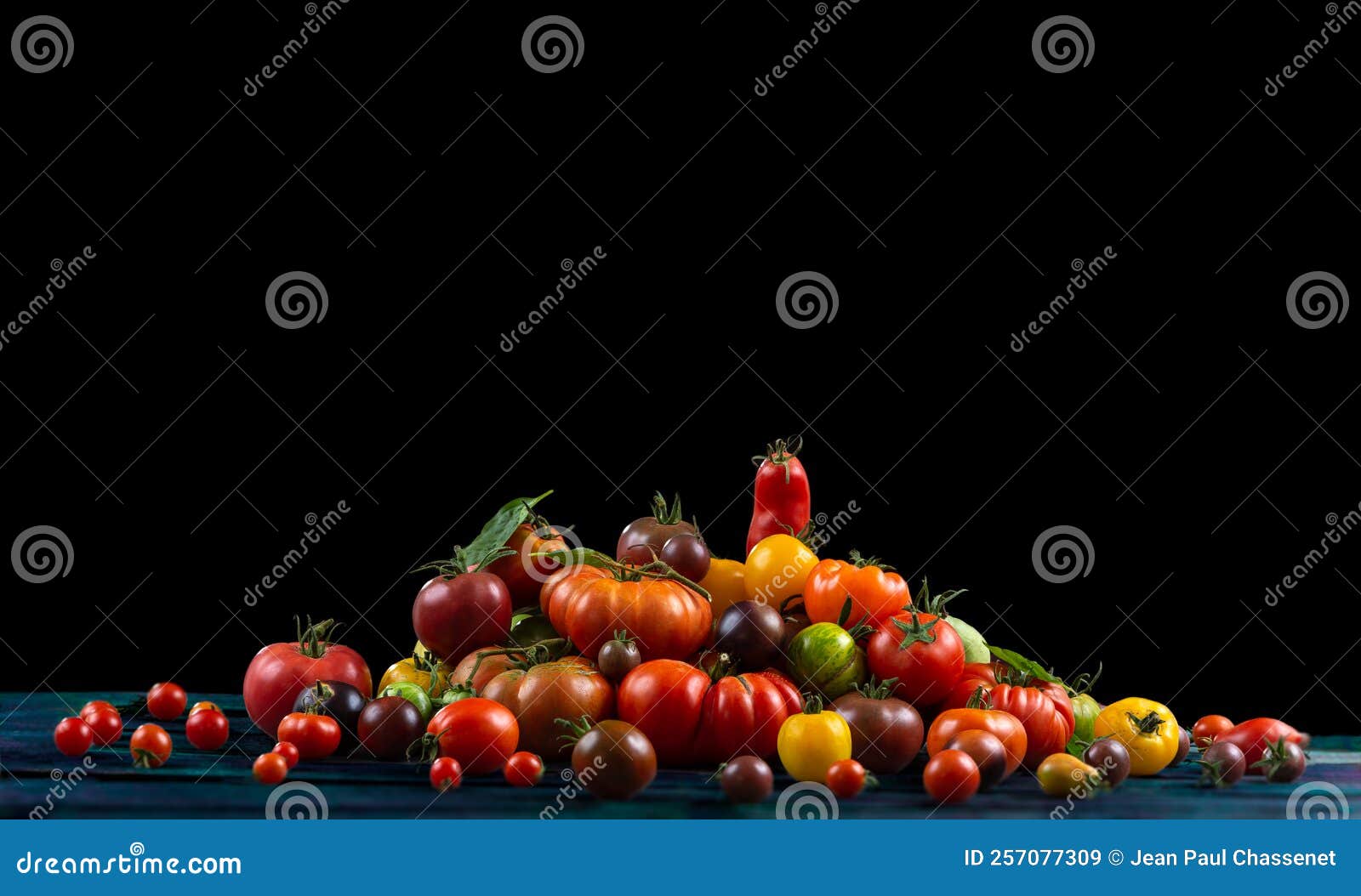 old tomatoes stacked in pyramid placed on old green board