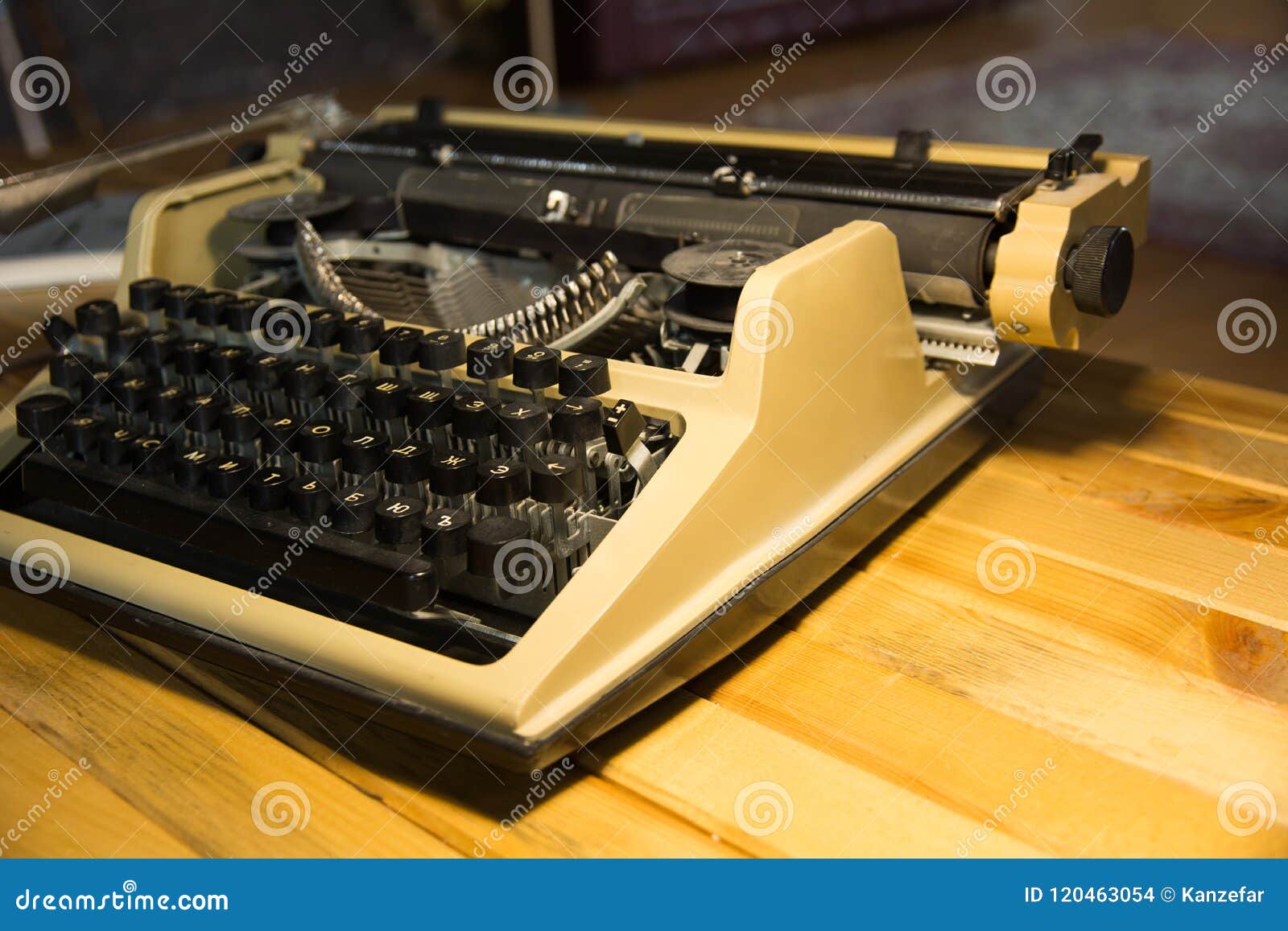 An Old Typewriter Illuminated by a Lamp on a Wooden Lacquered Table