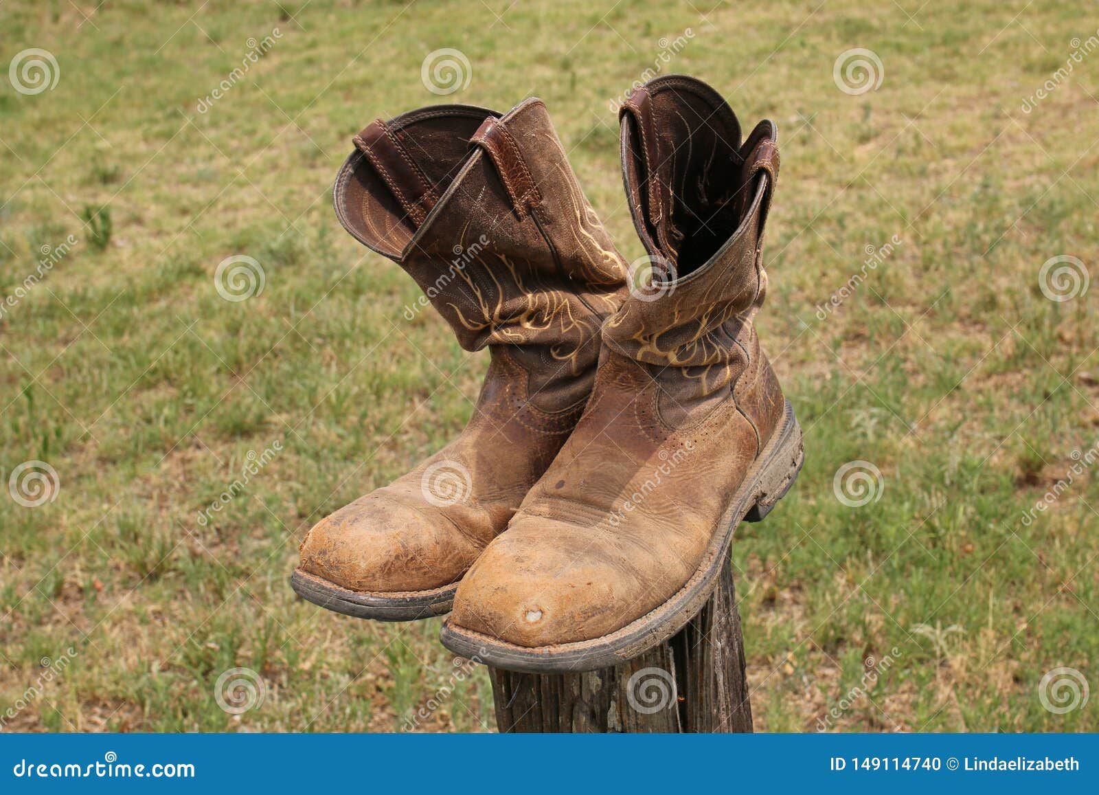 Old Used Cowboy Boots Balanced On A 
