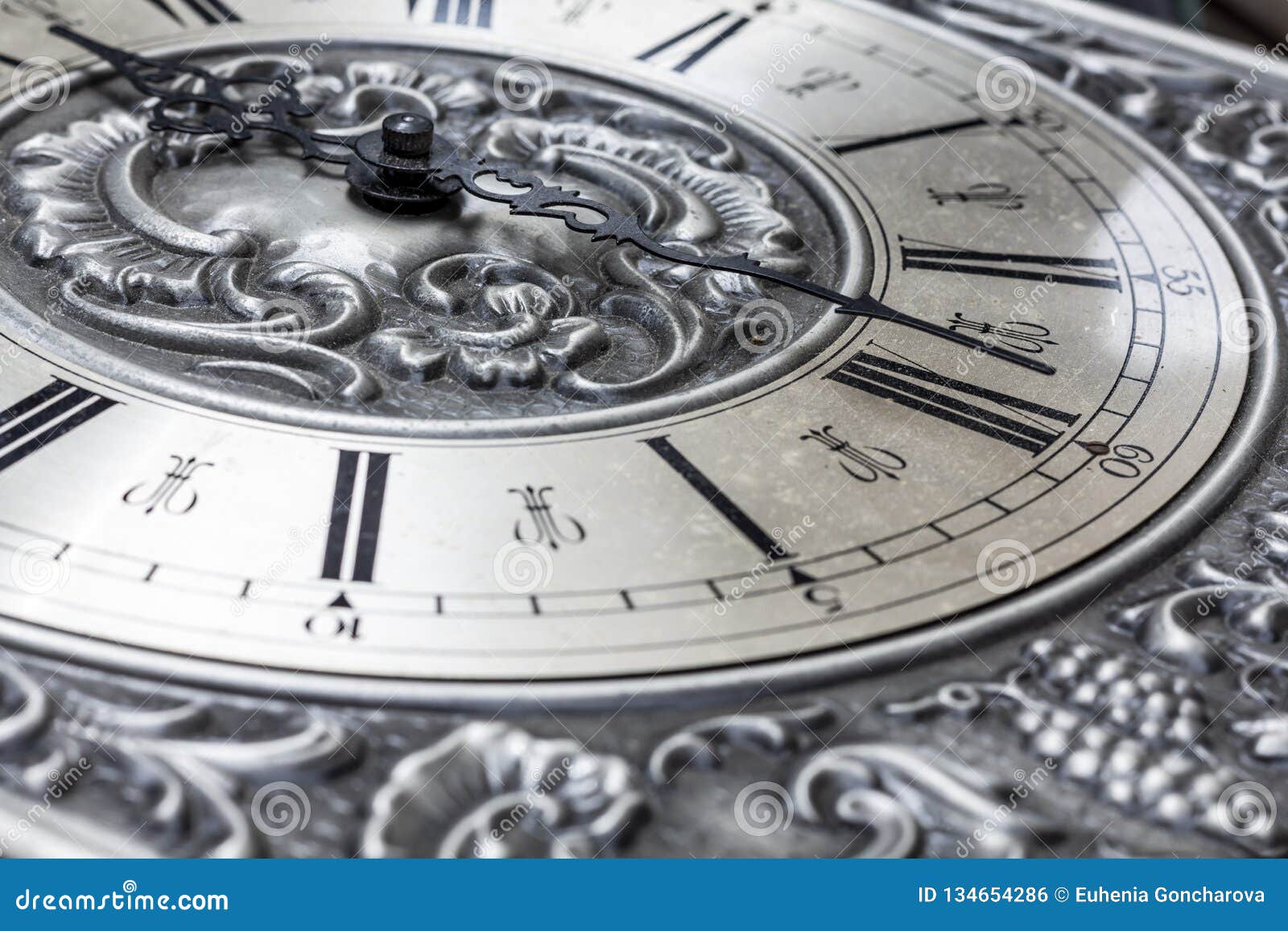 Old Vintage Clock with Metal Dial and Floral Embossed Pattern Closeup