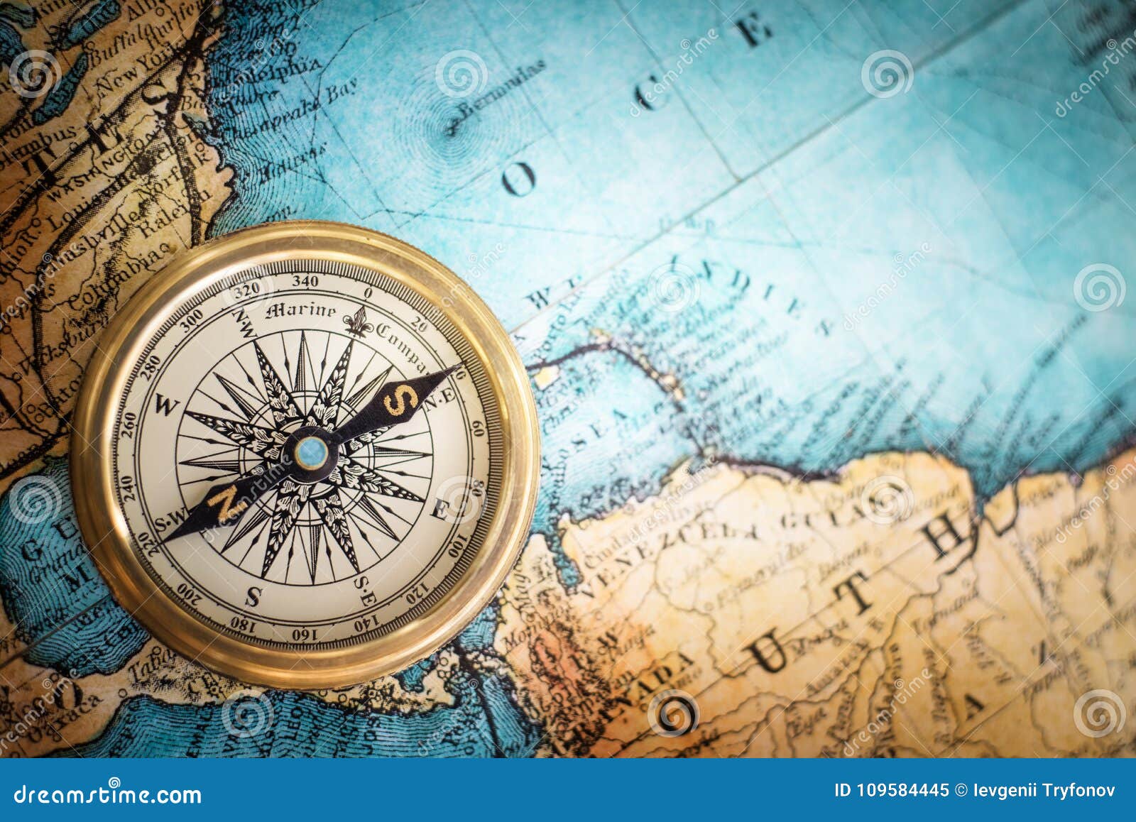 old vintage retro compass on ancient map background.