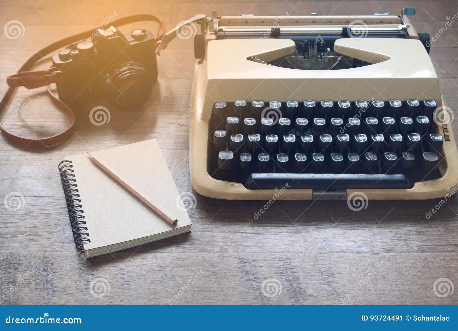 Old Vintage Typewriter, Film Camera and Blank Notebook on Rustic Wooden Table Stock Image