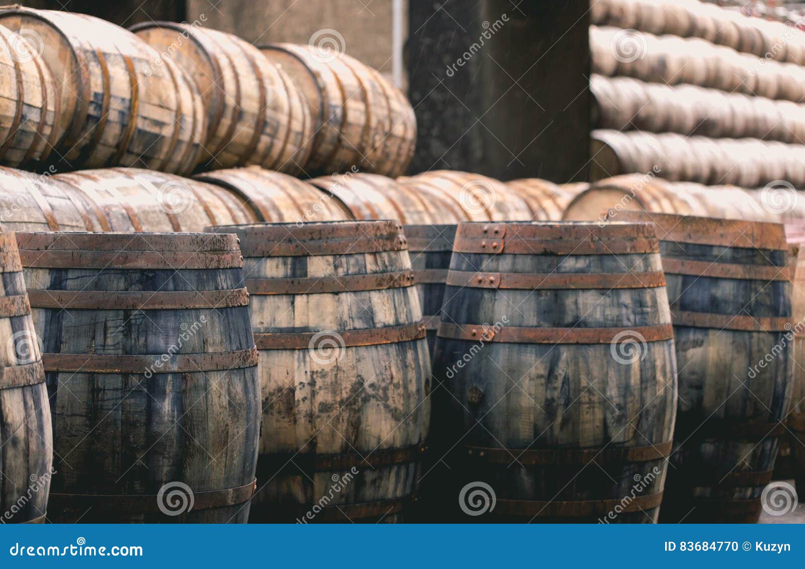 old vintage whisky barrels filled of whiskey placed in order in