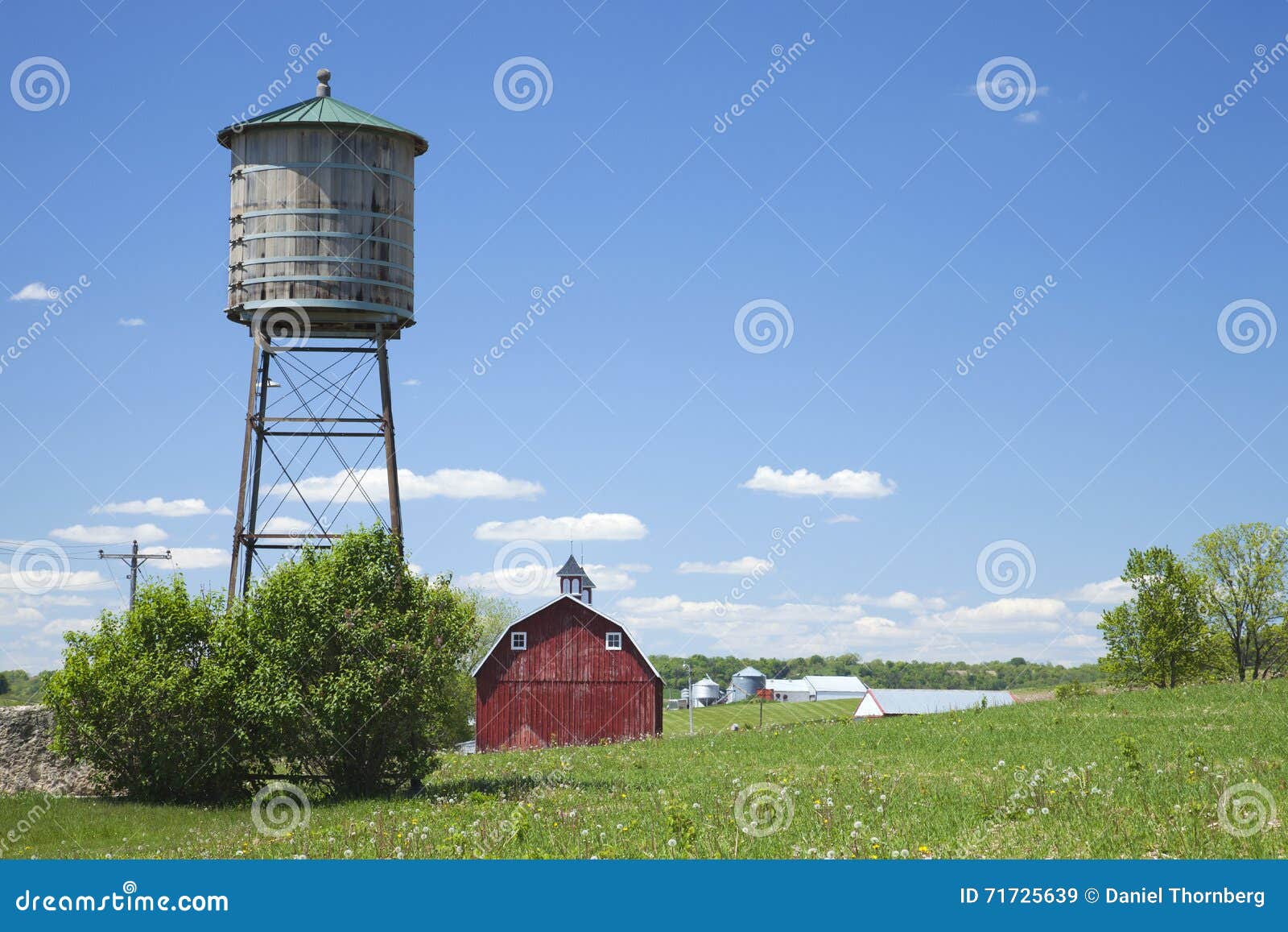 old water cistern and red barn in rural iowa