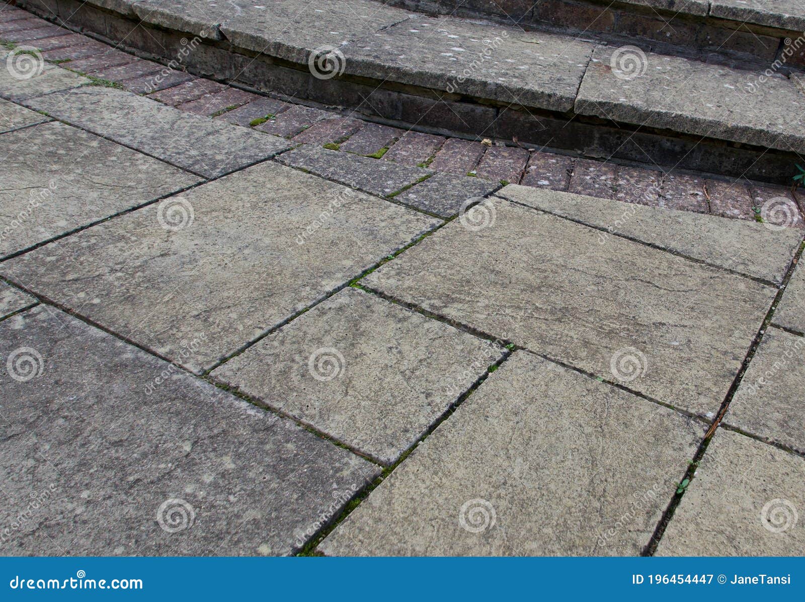 old weather stained paving patio background with steps and bricks