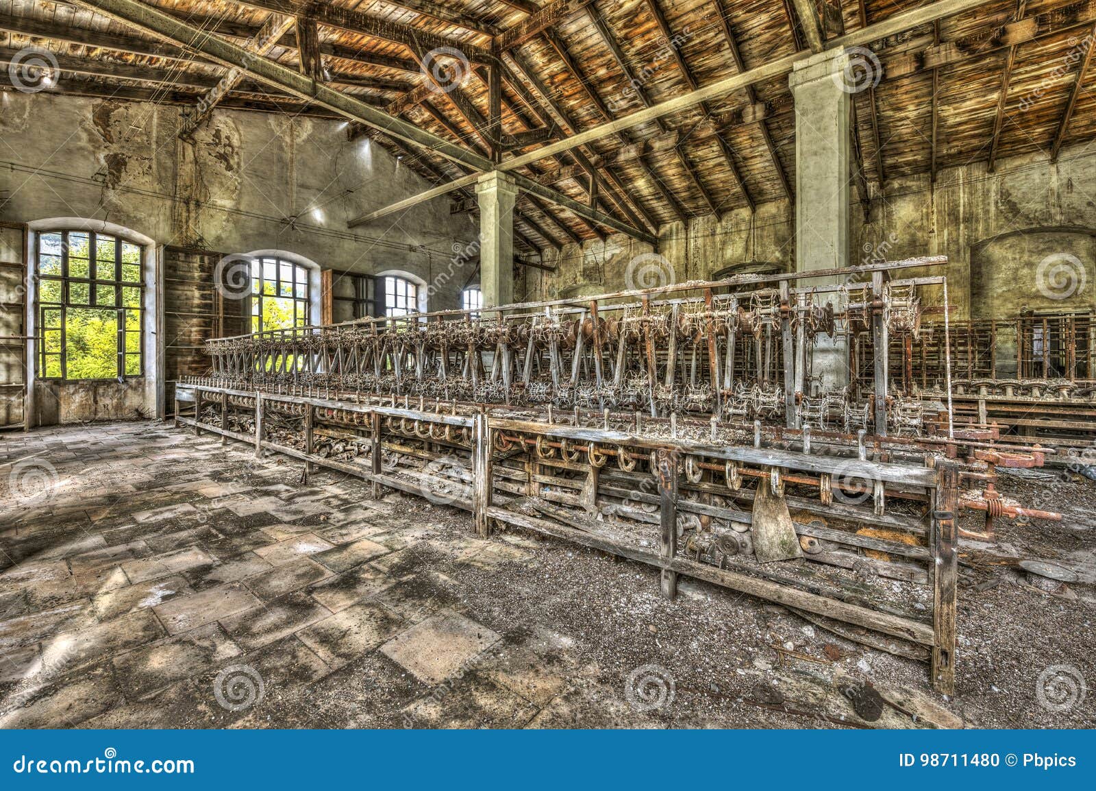 old weaving looms and spinning machinery at an abandoned factory