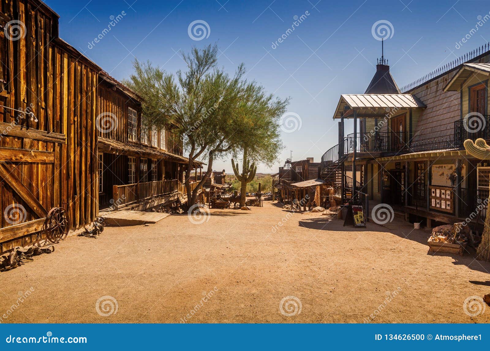 old western goldfield ghost town square with huge cactus and saloon, photo taken during the sunny day