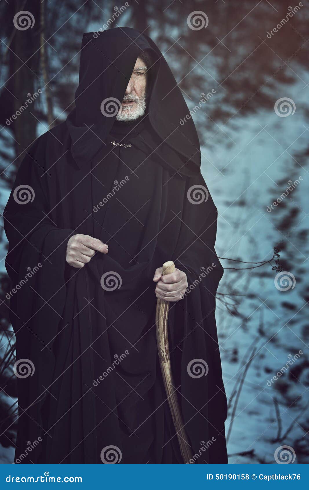 old white beard pilgrim in dark forest with snow