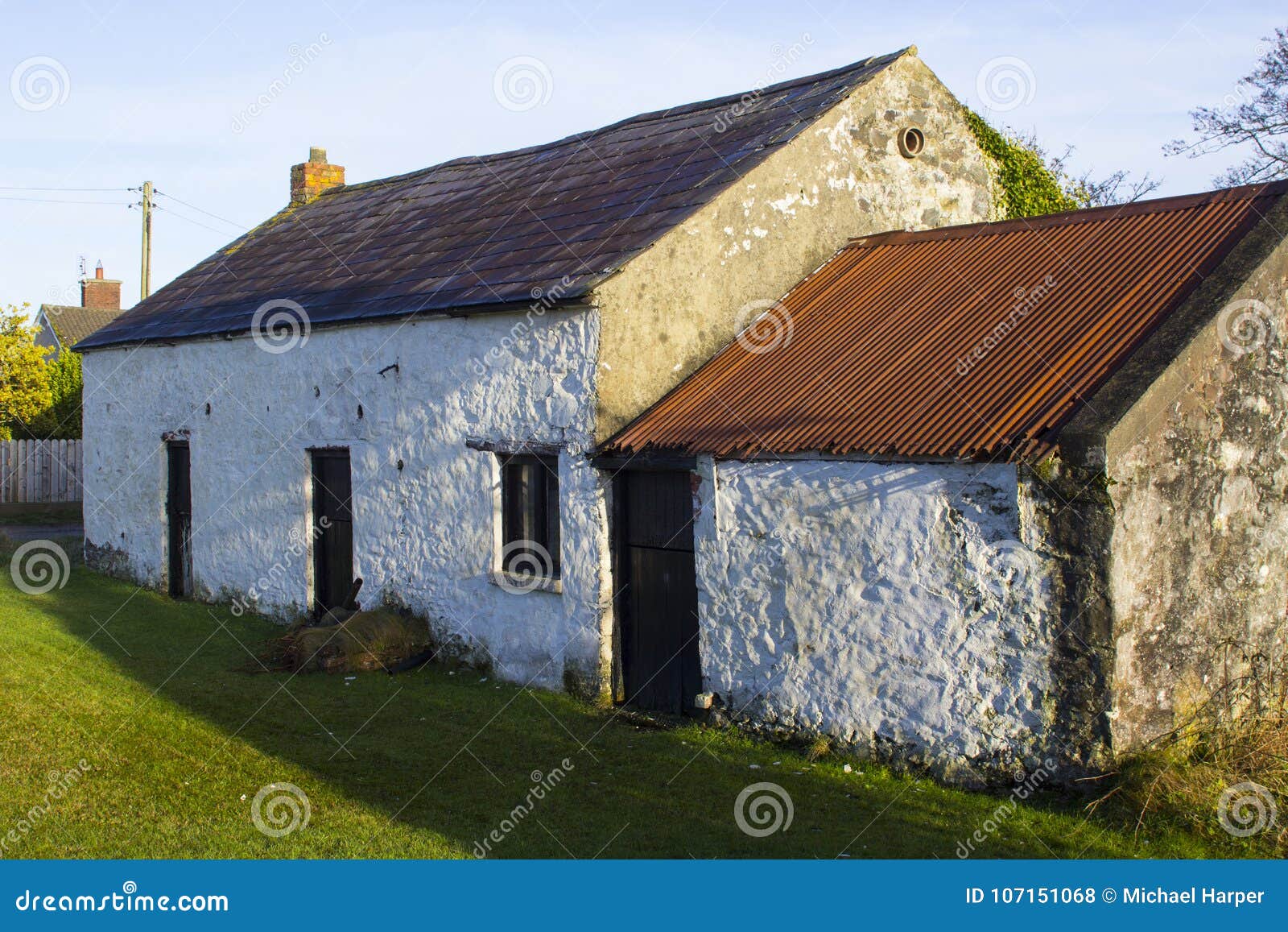 An Old Whitewashed Stone Built Irish Cottage With A Small Annex