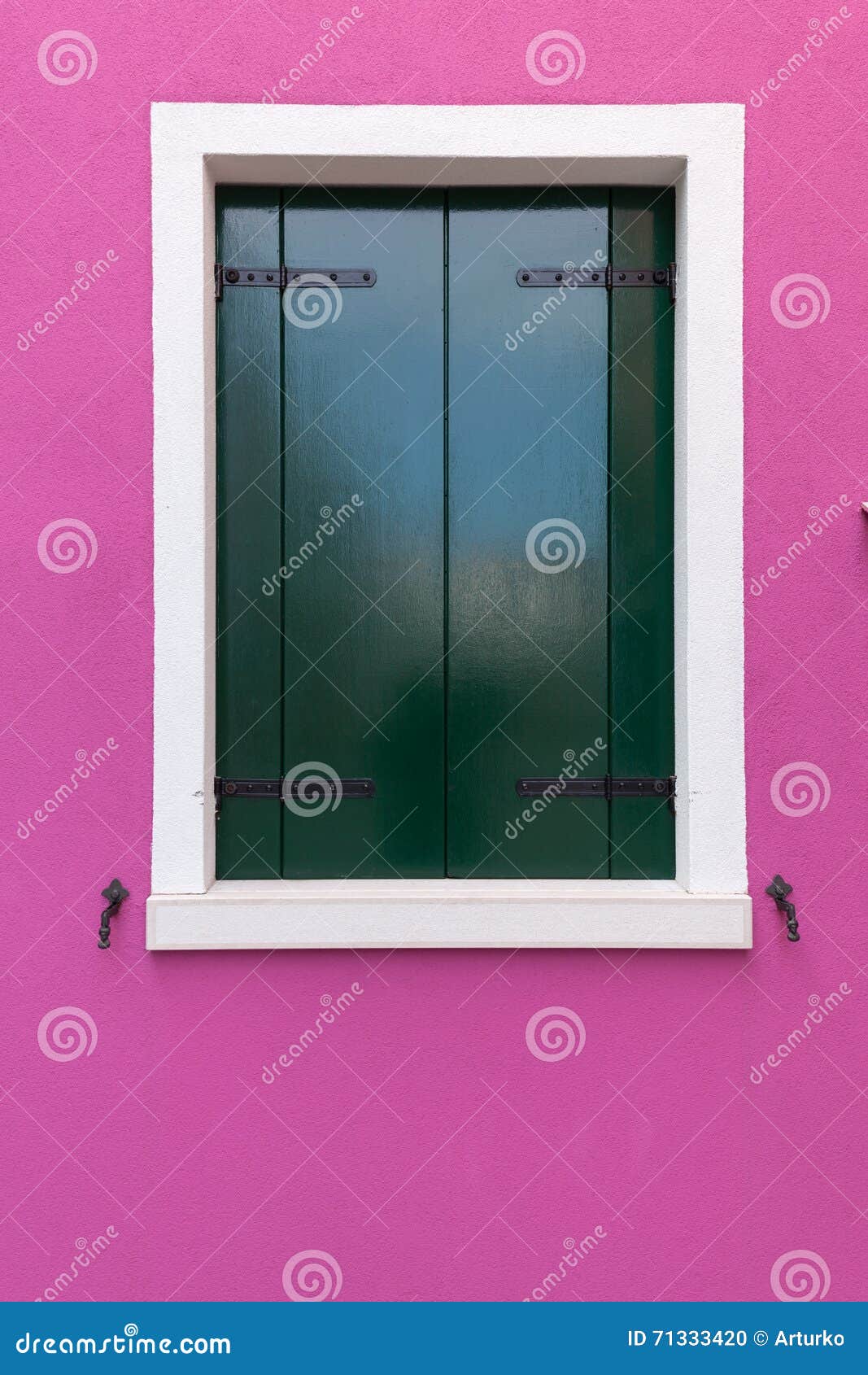 old window with dark green shutters on pink (fucsia) wall