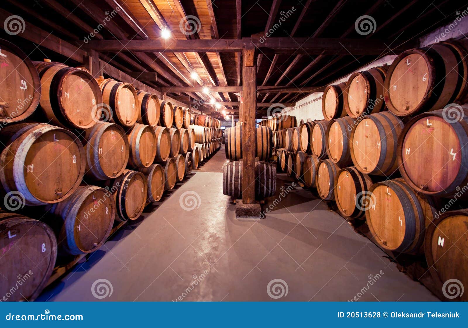 old wine cellar with barrels in stacks