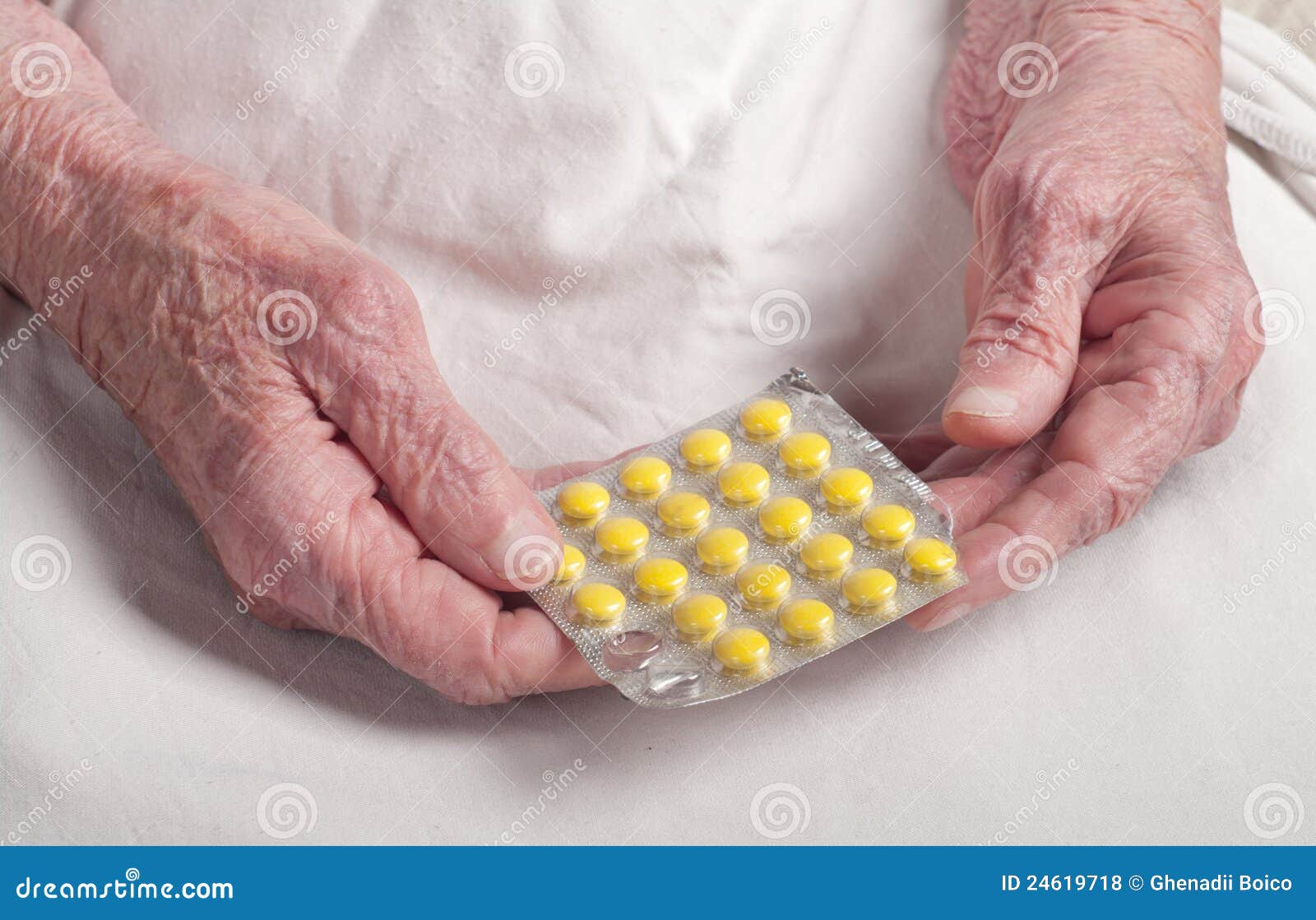 Pill on the hands of old woman