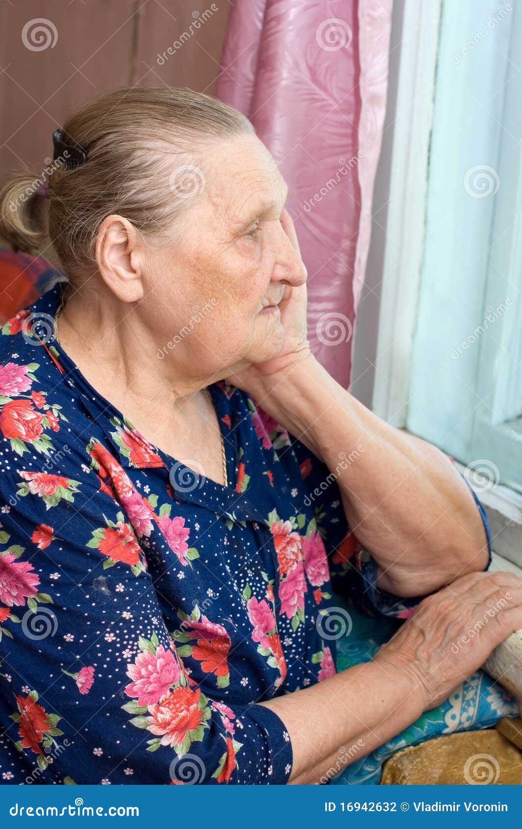 the old woman looks out of the window