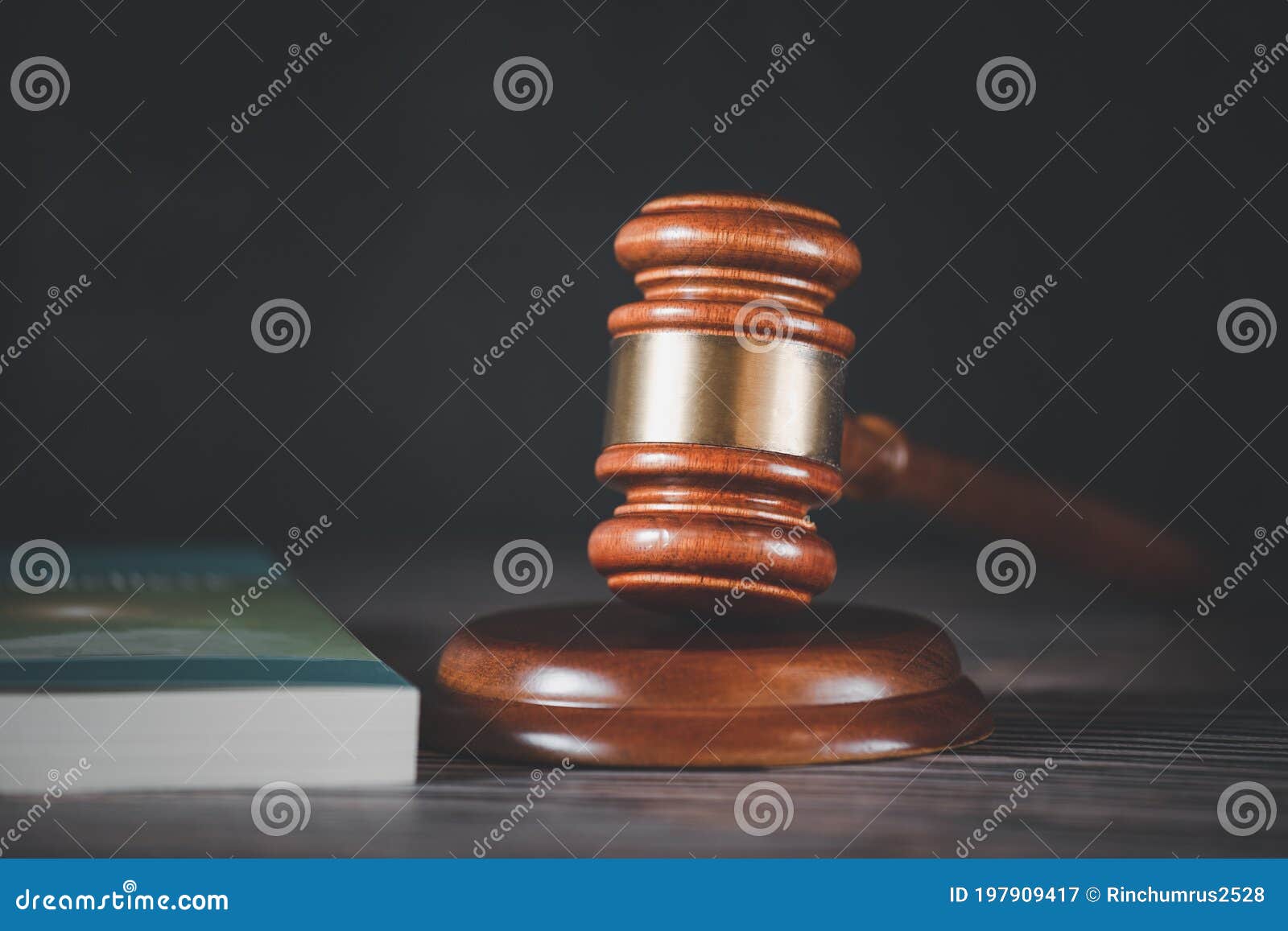 old wood judge hammer with law book on the table wood background, used for adjudication and justice