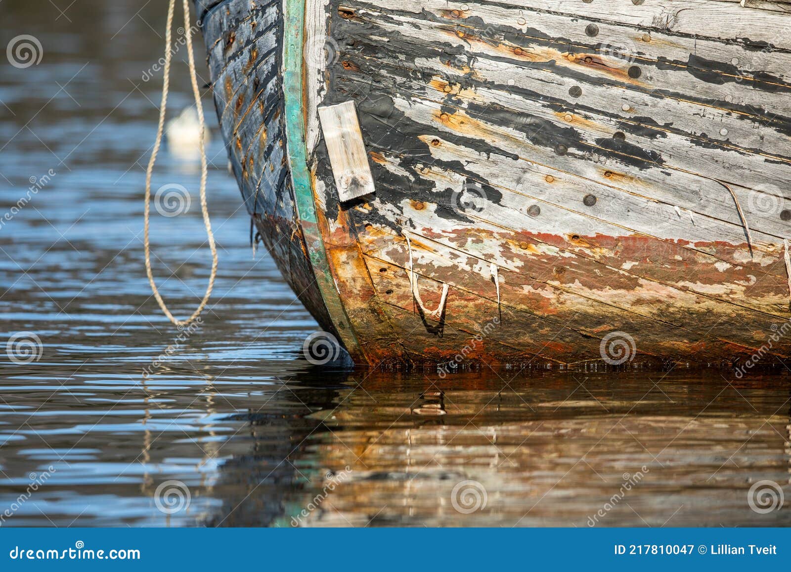 https://thumbs.dreamstime.com/z/old-wooden-fishing-boat-water-needs-painting-paint-gone-texture-visible-might-sink-calm-sea-rope-hanging-217810047.jpg