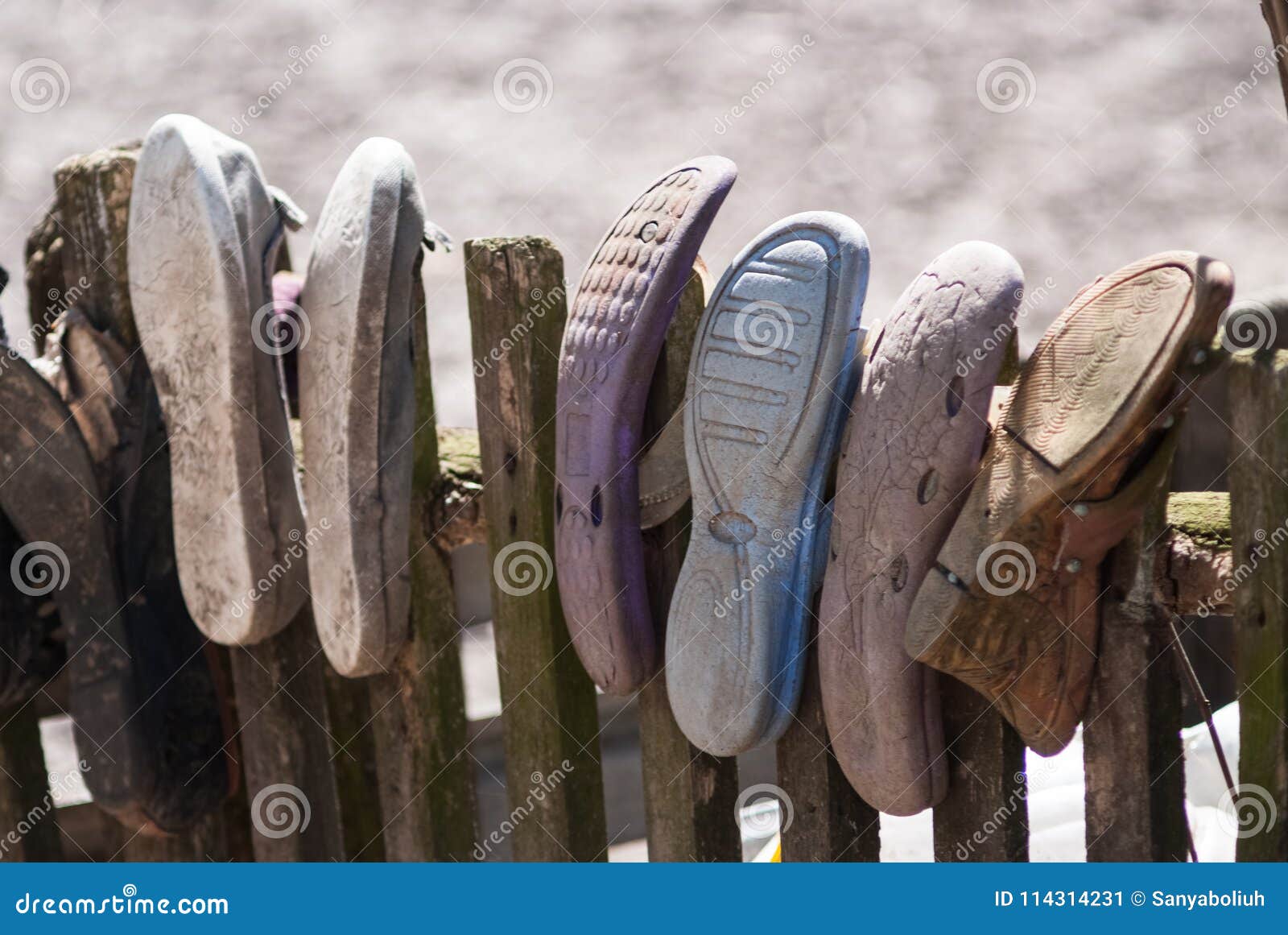 Old Worn House Slippers on Wooden Fence. the Concept of Poverty Stock ...