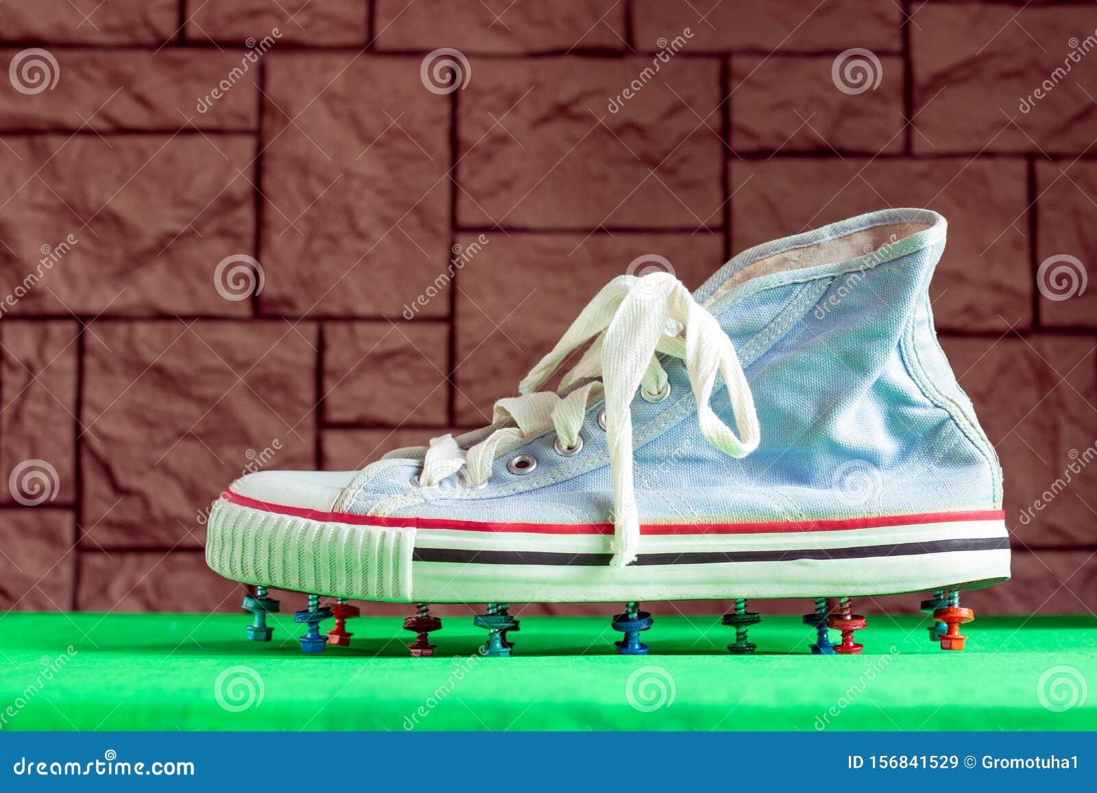 An Old Worn Out Football Sneaker With Multicolored Roofing Screws Instead Of Spikes Stands Forgotten On A Closed Football Ground Stock Image Image Of Money Matches 156841529