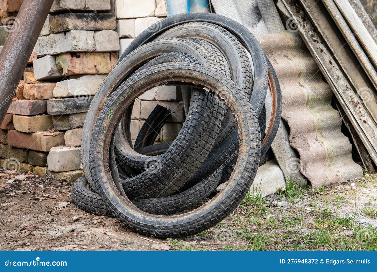 Old, Wornout Motorcycle and Bicycle Tires. Recycling Stock Photo