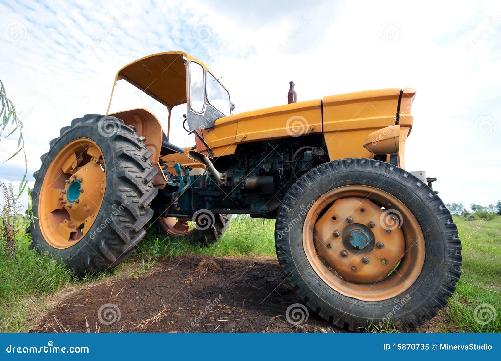 Old yellow farm tractor stock image. Image of industrial 15870735