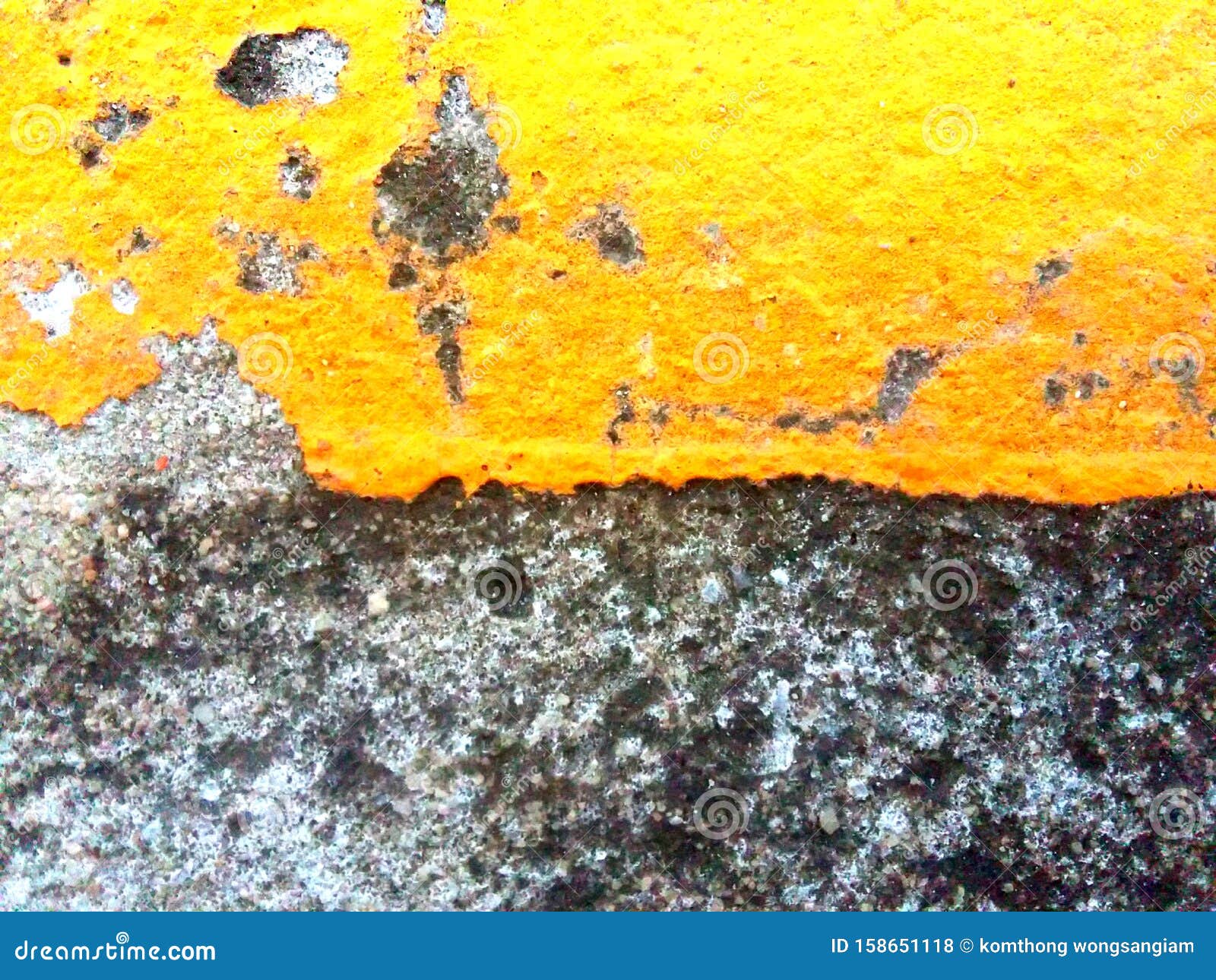 The Old Yellow Paint that Peels Off the Concrete Surface is Unstable, Uneven. Old Paint and Old