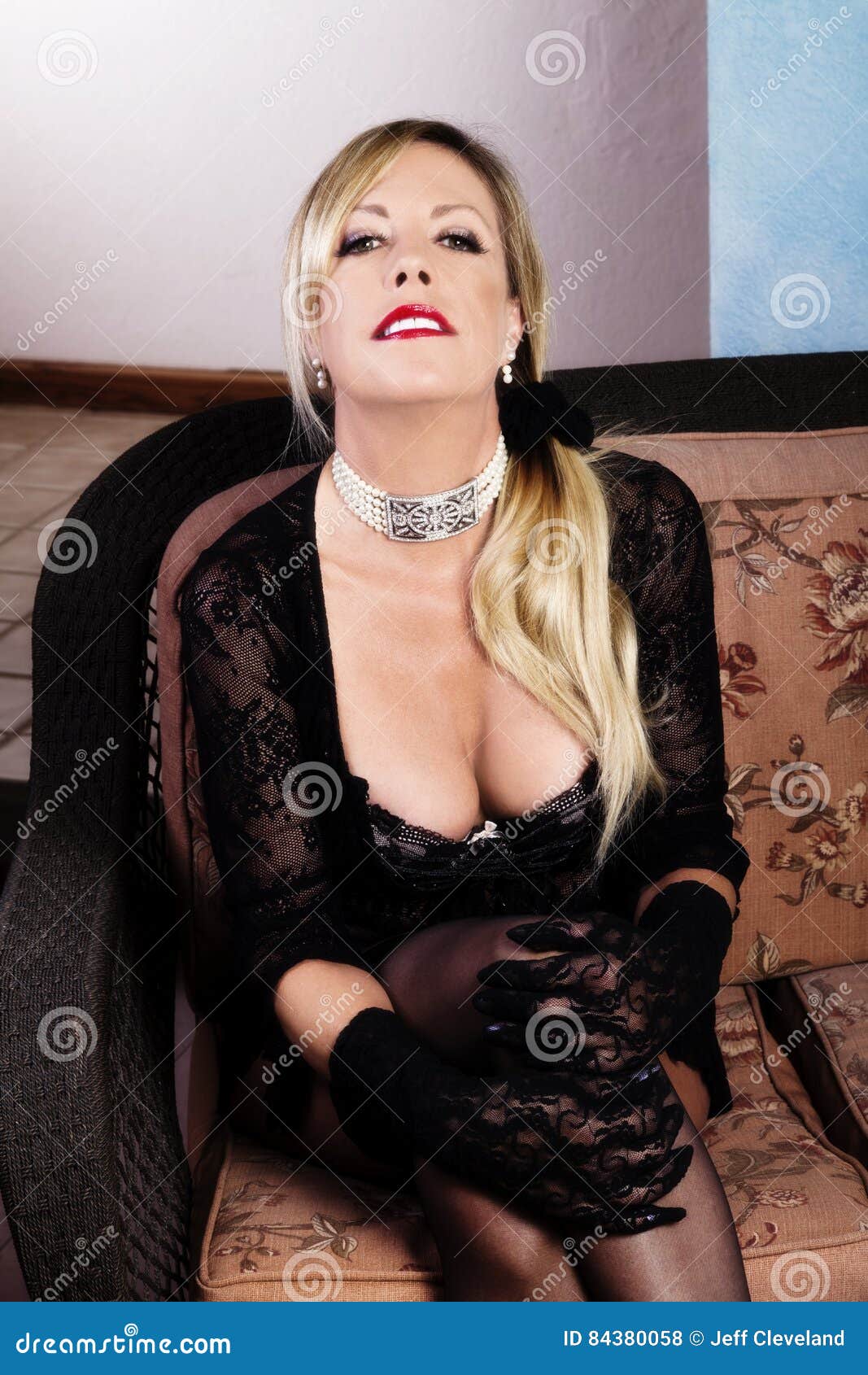Older Blond Caucasian Woman Sitting in Lace Lingerie Stock Photo