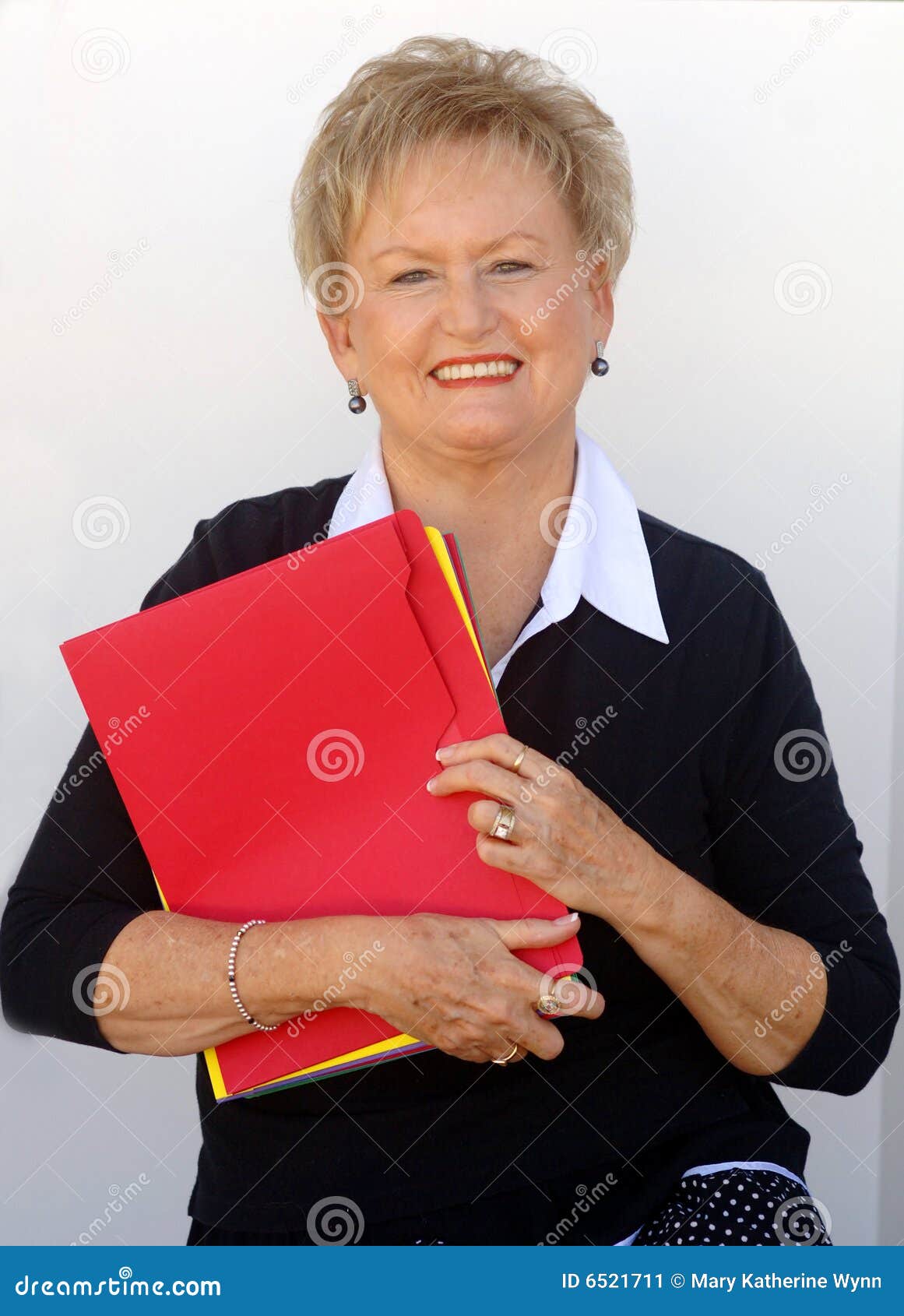 older business woman with file folders