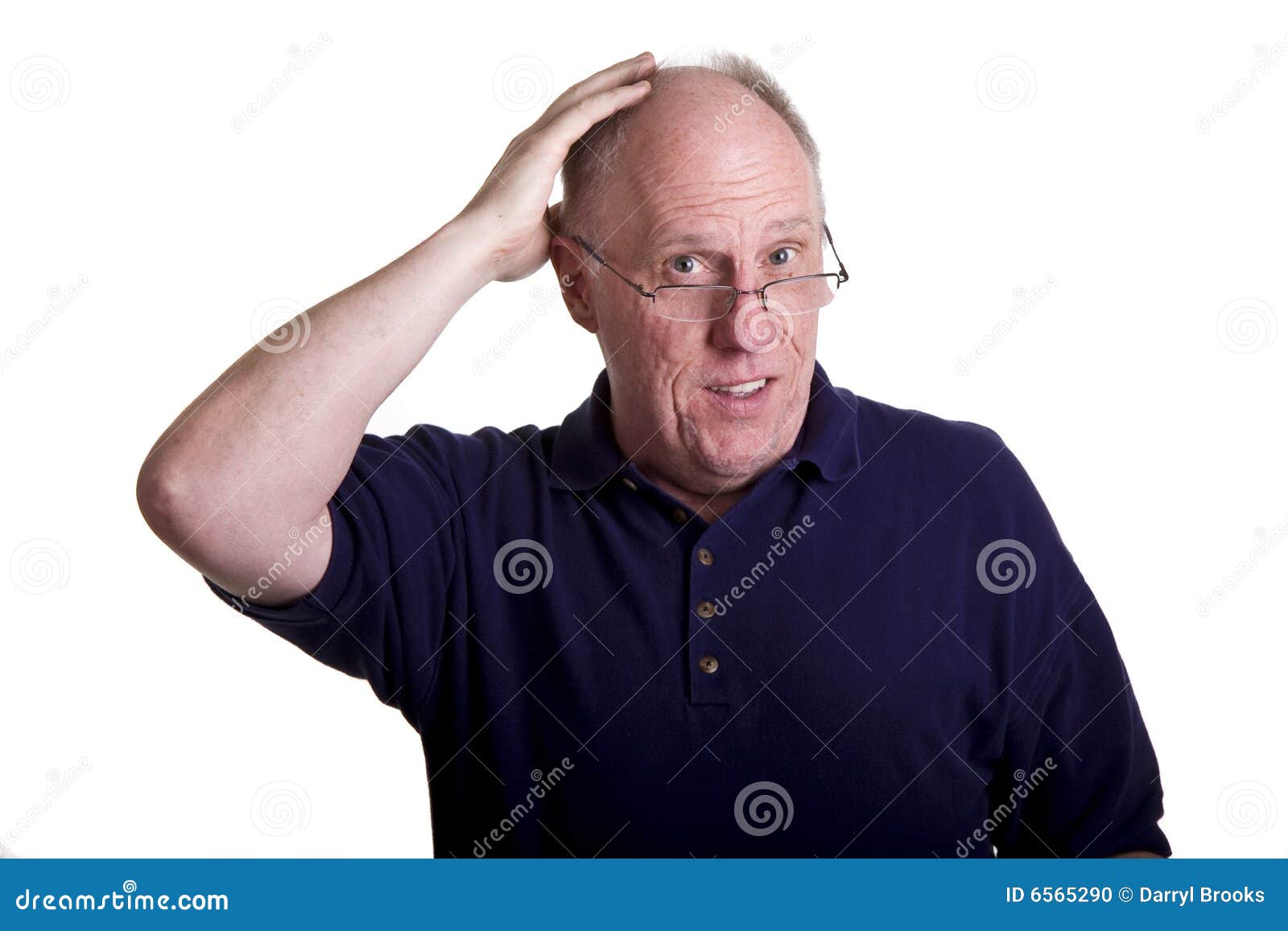 An Older Man In Blue Shirt Rubbing Bald Head Stock Photo Image Of