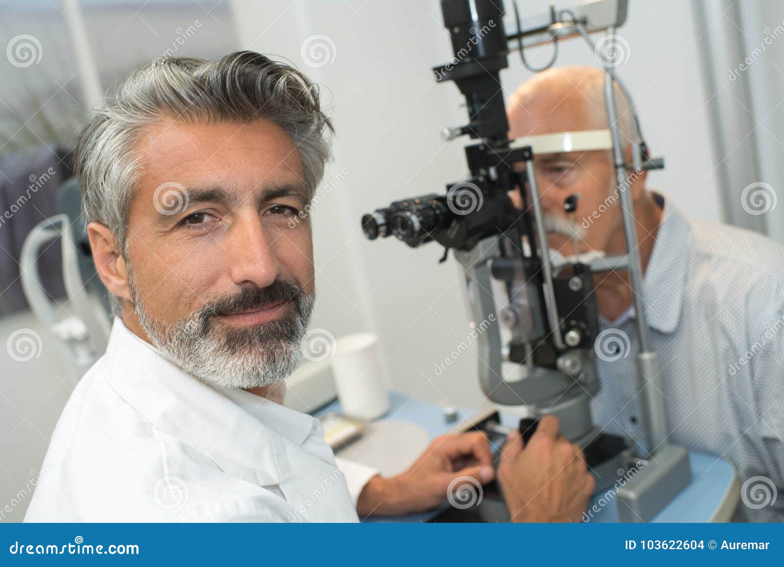 older man taking eye test examination