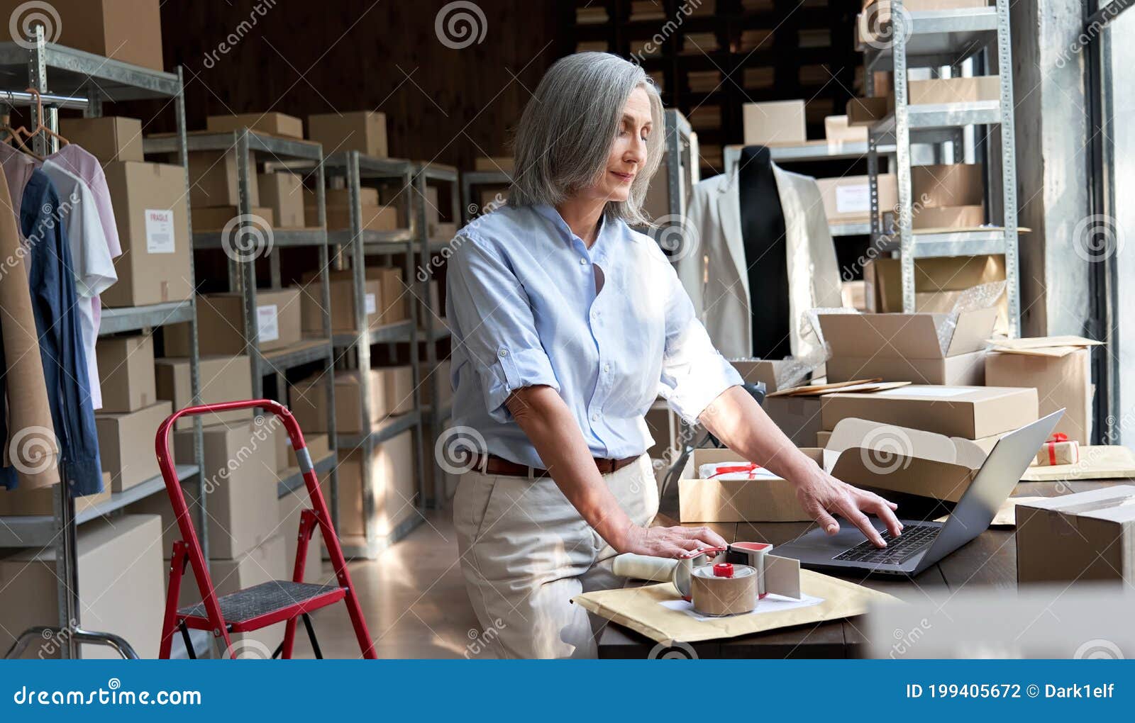 older business woman seller using laptop checking ecommerce dropshipping orders.