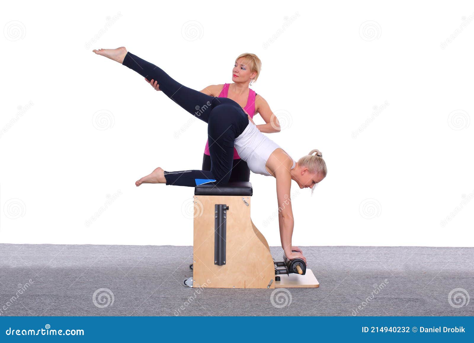 A 50-year-old Trainer Teaches a Young Girl To Practice Pilates on an  Elevator Chair by Lifting Her Leg High Above Her Stock Photo - Image of  woman, side: 214940232