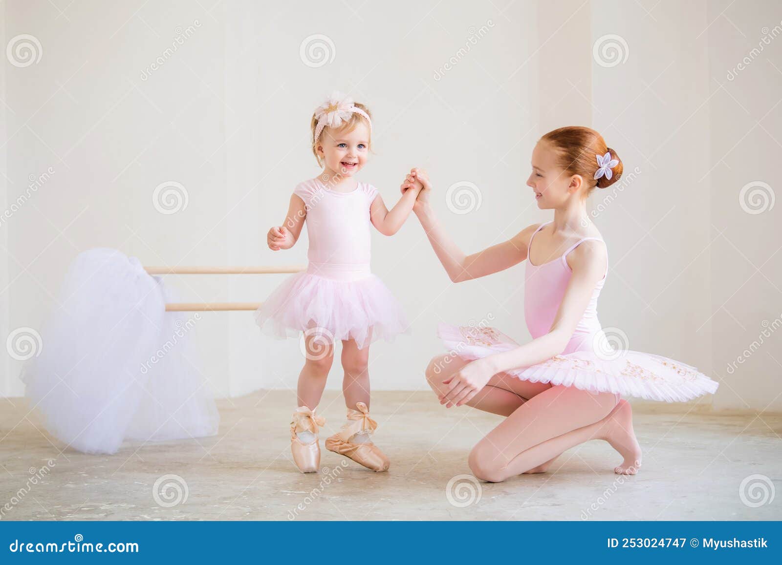 The Older Sister, a Ballerina in a Pink Tutu and Pointe Shoes