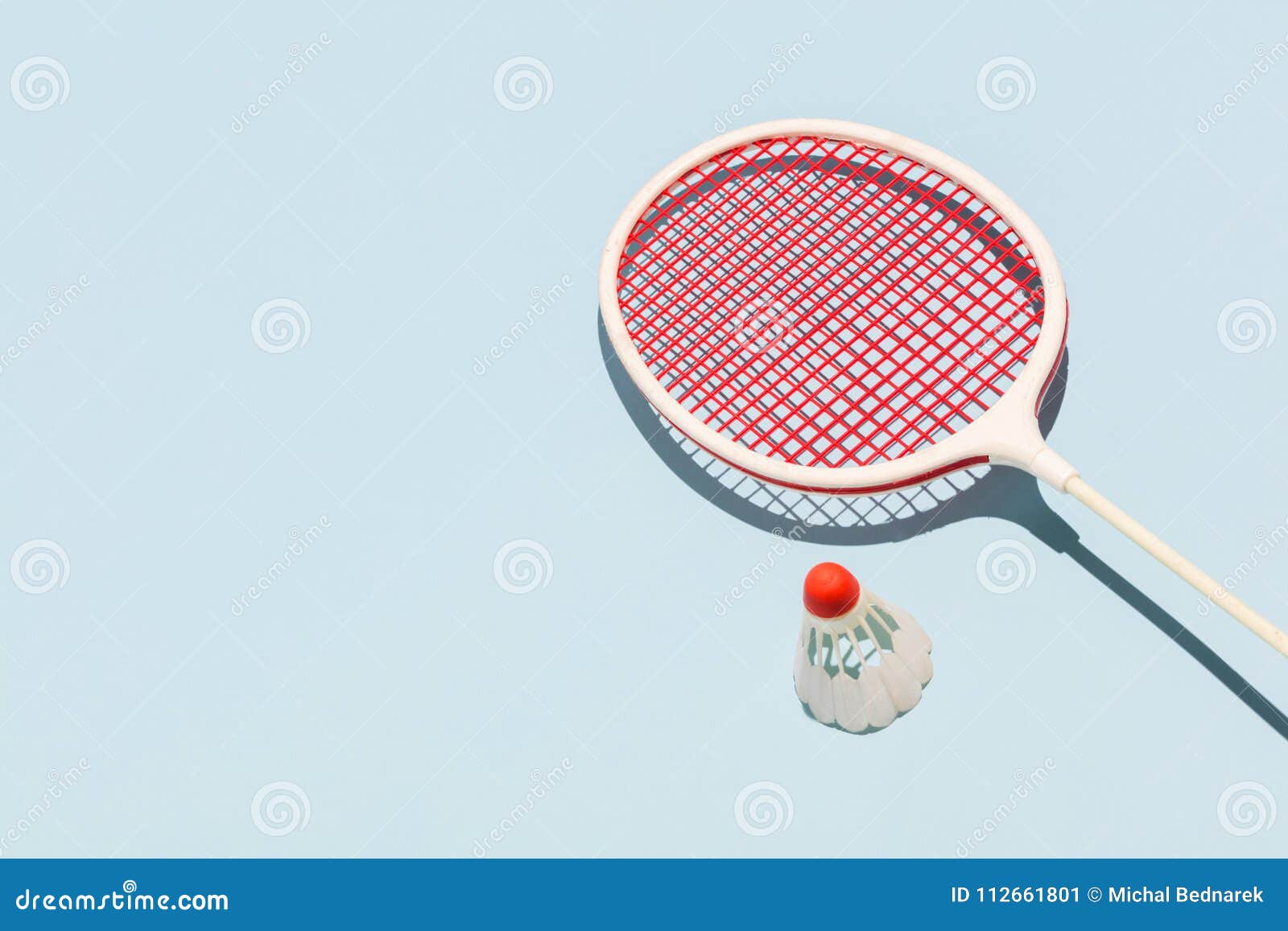oldschool racket and birdie on blue background