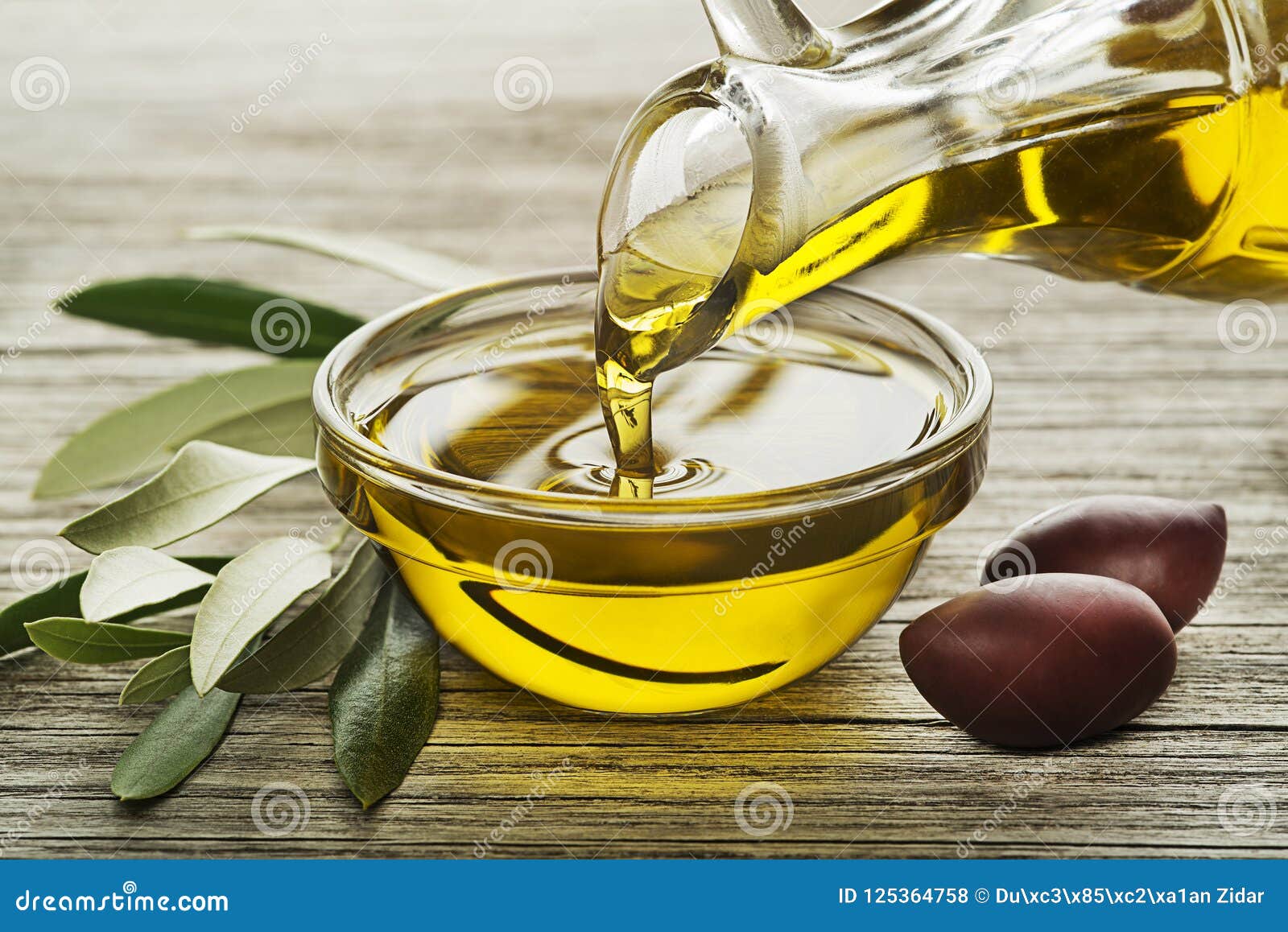 olive oil bottle pouring in bowl